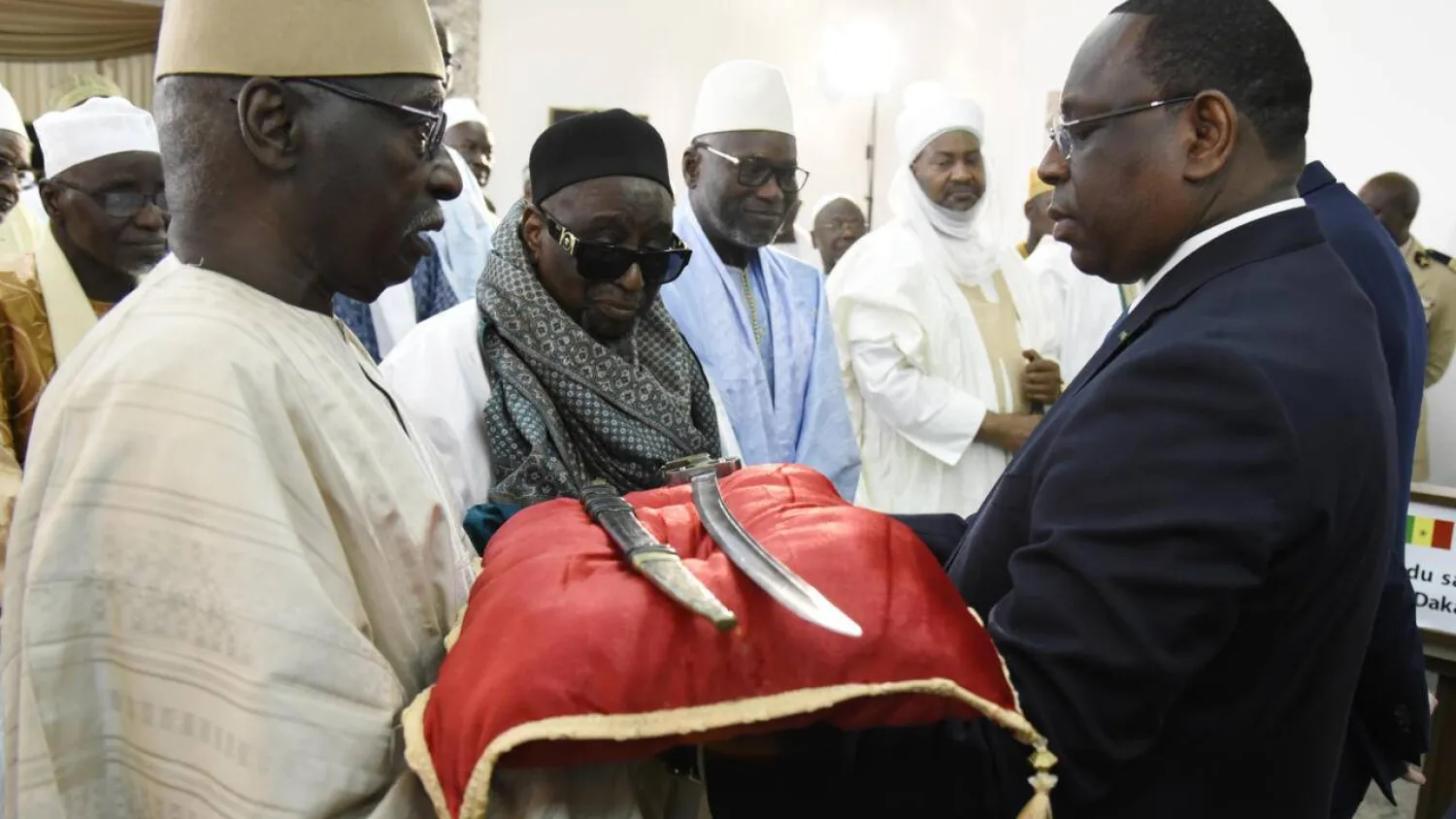 In 2019, France returned a 19th-century sword to Senegal's then-President Macky Sall (right). (AFP) 