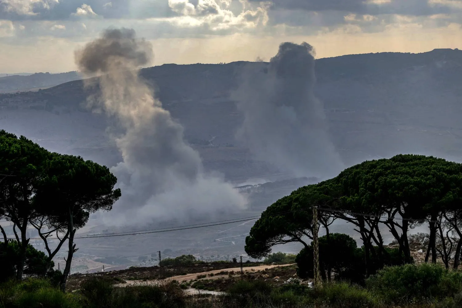 This picture taken from the southern Lebanese area of Marjayoun, shows smoke rising from the area of al-Khardali following an Israeli airstrike on July 31, 2025. (Photo by Rabih DAHER / AFP)