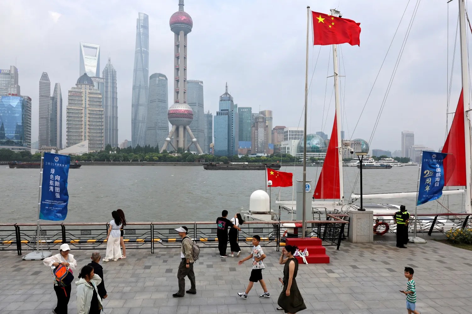 FILE PHOTO: People walk on a promenade in Shanghai, China, July 10, 2025. REUTERS/Go Nakamura/File Photo