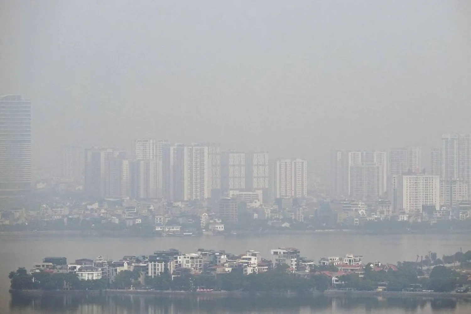 Commercial buildings and residential neighborhoods are shrouded behind heavy air pollution in Hanoi on July 30, 2025. (AFP)
