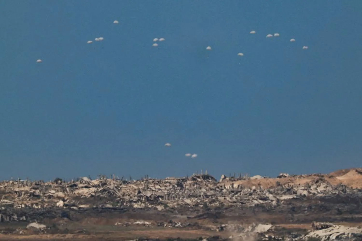 Humanitarian aid packages are airdropped over the Gaza Strip, as seen from Israel, August 1, 2025. (Reuters)