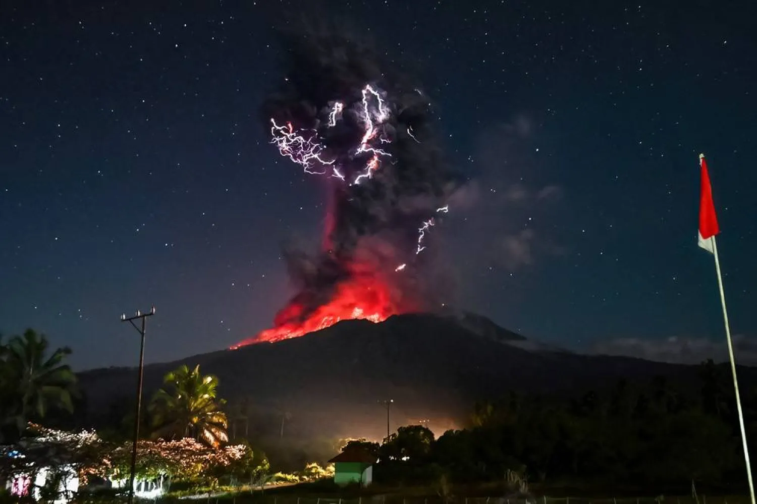 This handout photo taken and released on August 1, 2025 by Indonesia's Geological Agency shows Mount Lewotobi Laki-Laki spewing lava and volcanic ash up to approximately 10 kilometers high during its eruption as observed from the monitoring post in East Flores, in East Nusa Tenggara province. (Indonesia's Geological Agency / AFP) 