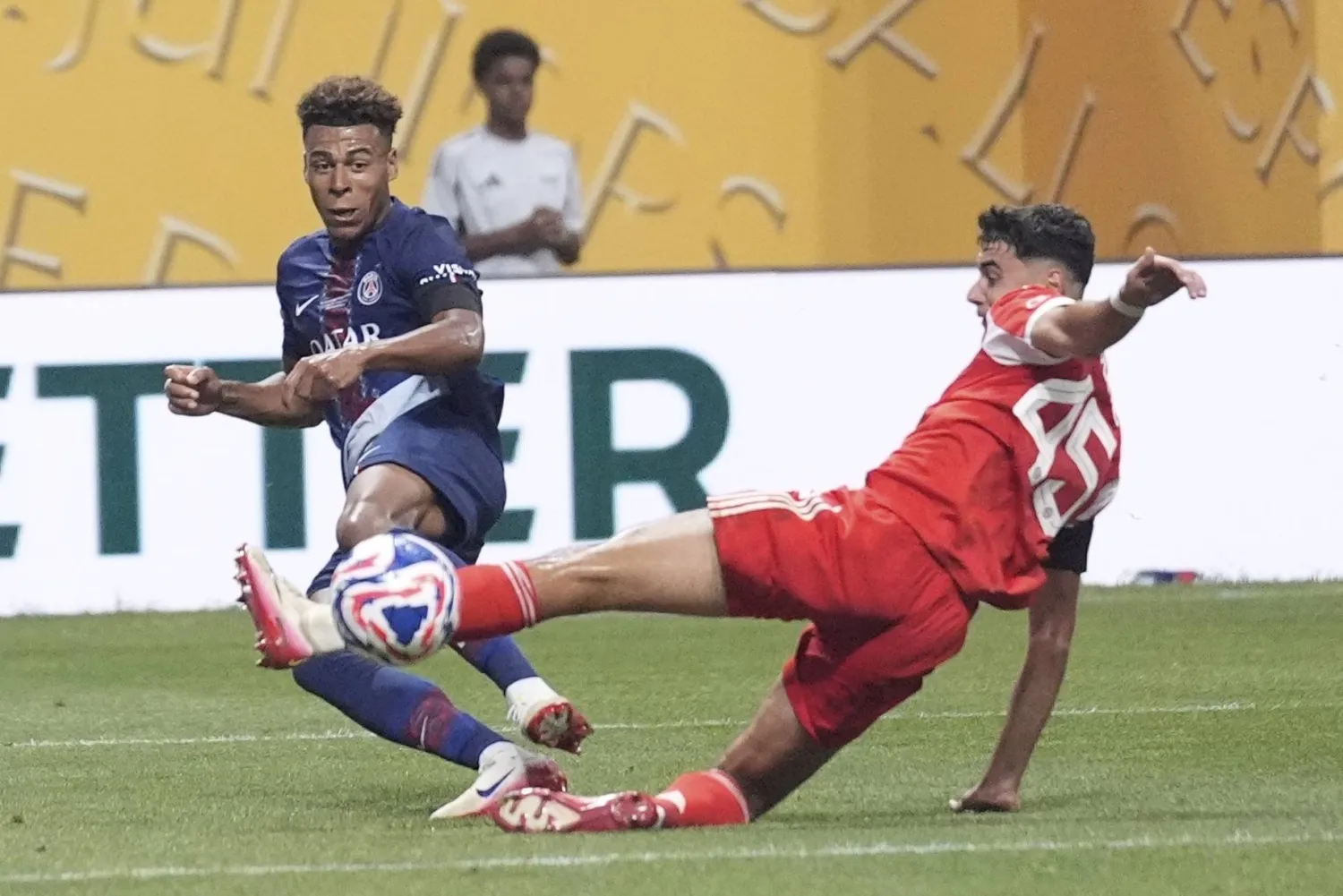 Bayern Munich's Aleksandar Pavlovic blocks the shot of Paris Saint-Germain's Desire Doue during the Club World Cup quarterfinal soccer match between PSG and Bayern Munich in Atlanta, Saturday, July 5, 2025. (AP Photo/Brynn Anderson)