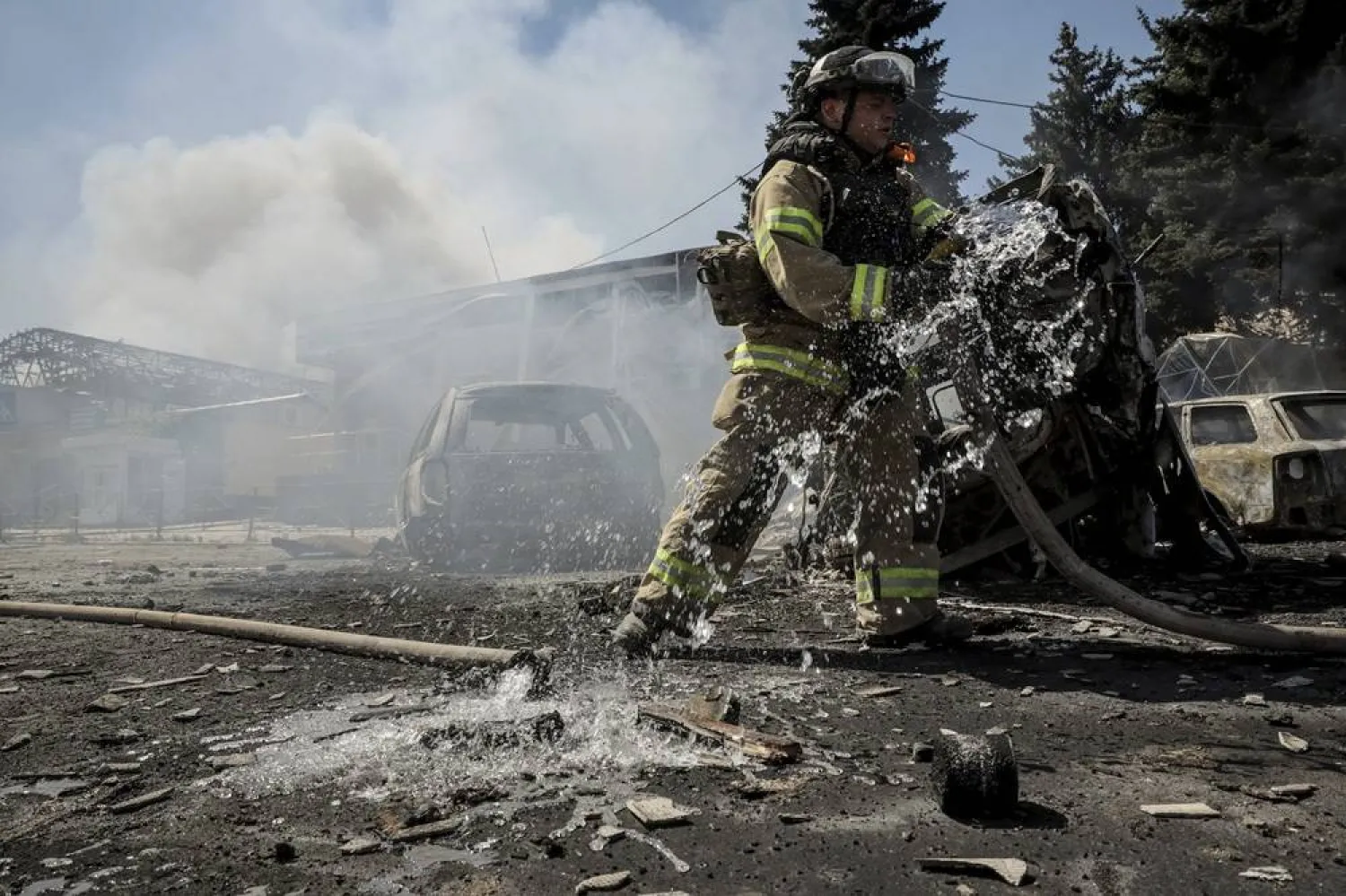 In this photo provided by Ukraine's 24th Mechanized Brigade press service, a firefighter puts out the fire after a Russian drone hit the market in the town of Druzhkivka, Donetsk region, Ukraine, Saturday, Aug. 2, 2025, (Oleg Petrasiuk/Ukraine's 24th Mechanized Brigade via AP) 
