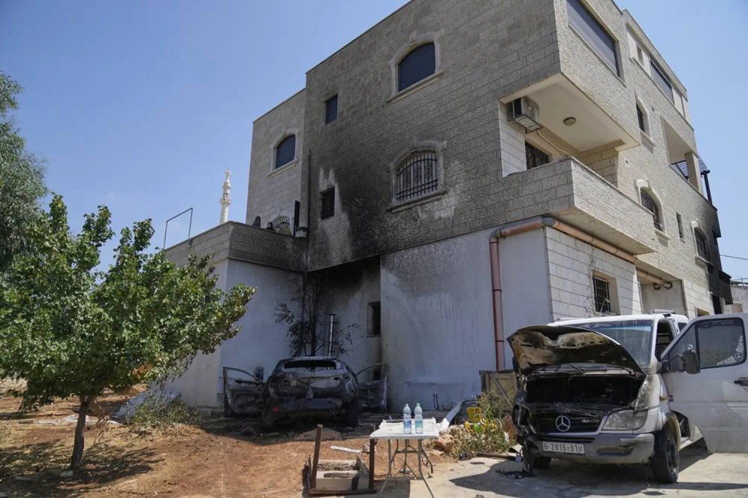 Women inspect the site of a burnt house and torched vehicles following a spree of violent rampage by Israeli settlers overnight that left one dead Palestinian American, a burnt house and several torched vehicles in three Palestinian towns, in the West Bank town of Silwad, east of Ramallah Thursday, July 31, 2025. (AP) 