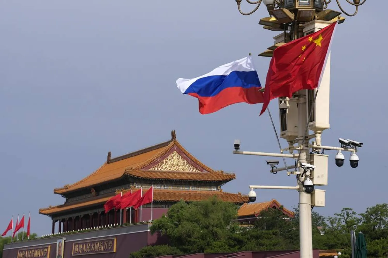 A Russian and Chinese national flag flutter near Tiananmen Gate for the visiting Russia's President Vladimir Putin, in Beijing, May 16, 2024. (AP) 