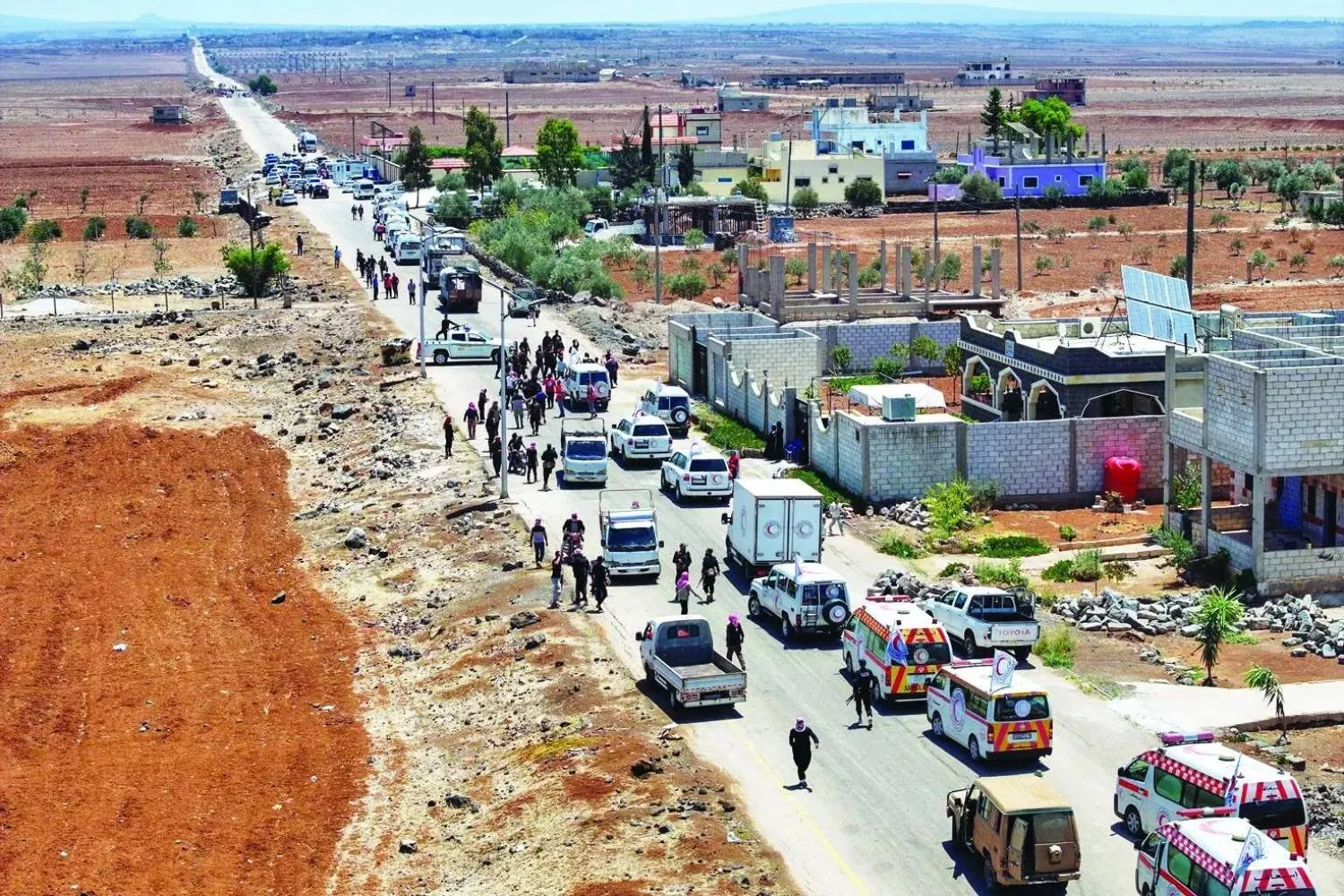 A Syrian Red Crescent convoy carrying humanitarian aid passes through the city of Bosra al-Sham en route to Sweida, July 20 (AFP). 