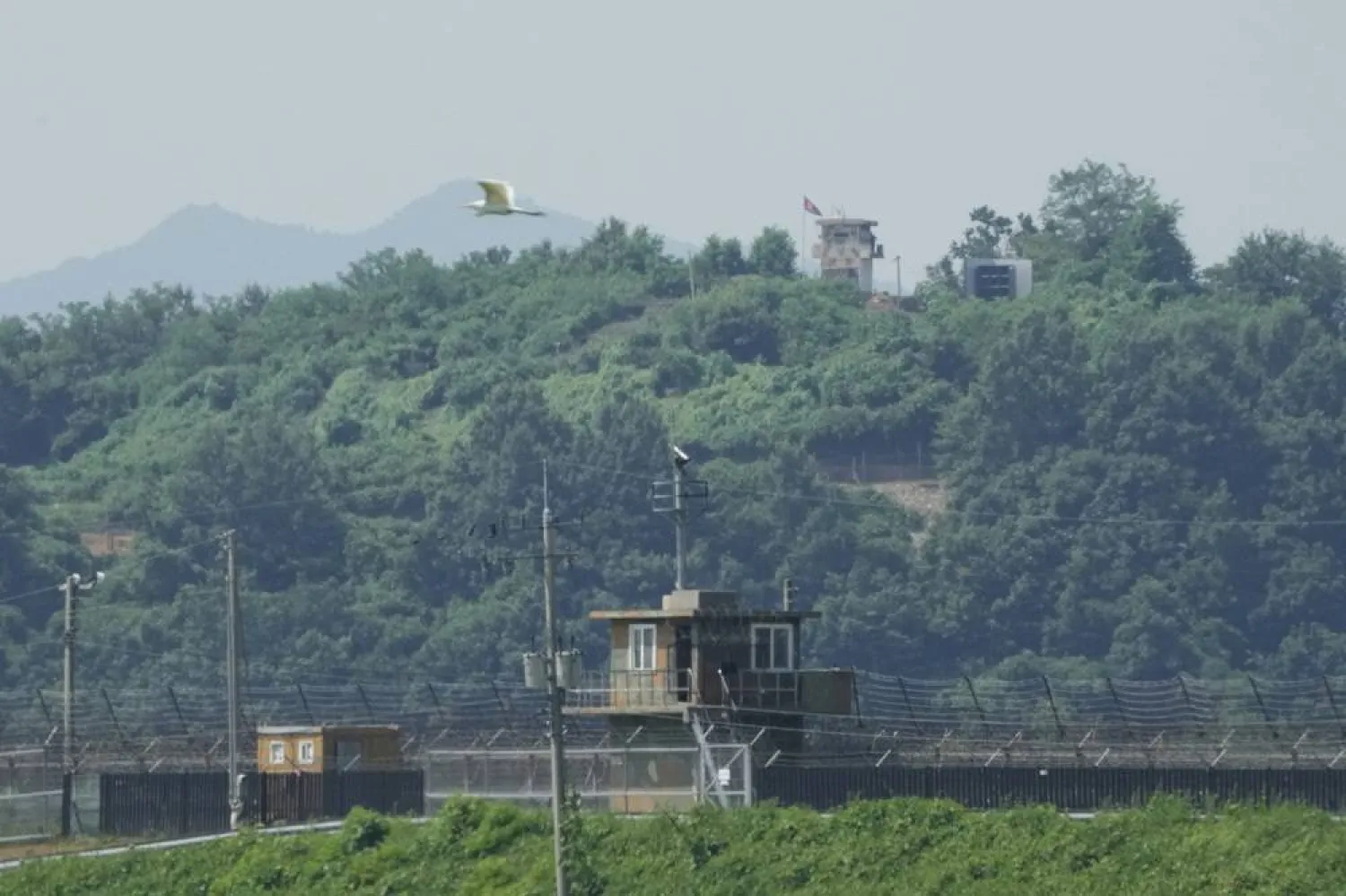  A North Korean military guard post, loudspeaker, top right, and South Korean military guard post, bottom, are seen from Paju, South Korea, near the border with North Korea, Monday, Aug. 4, 2025. (AP)