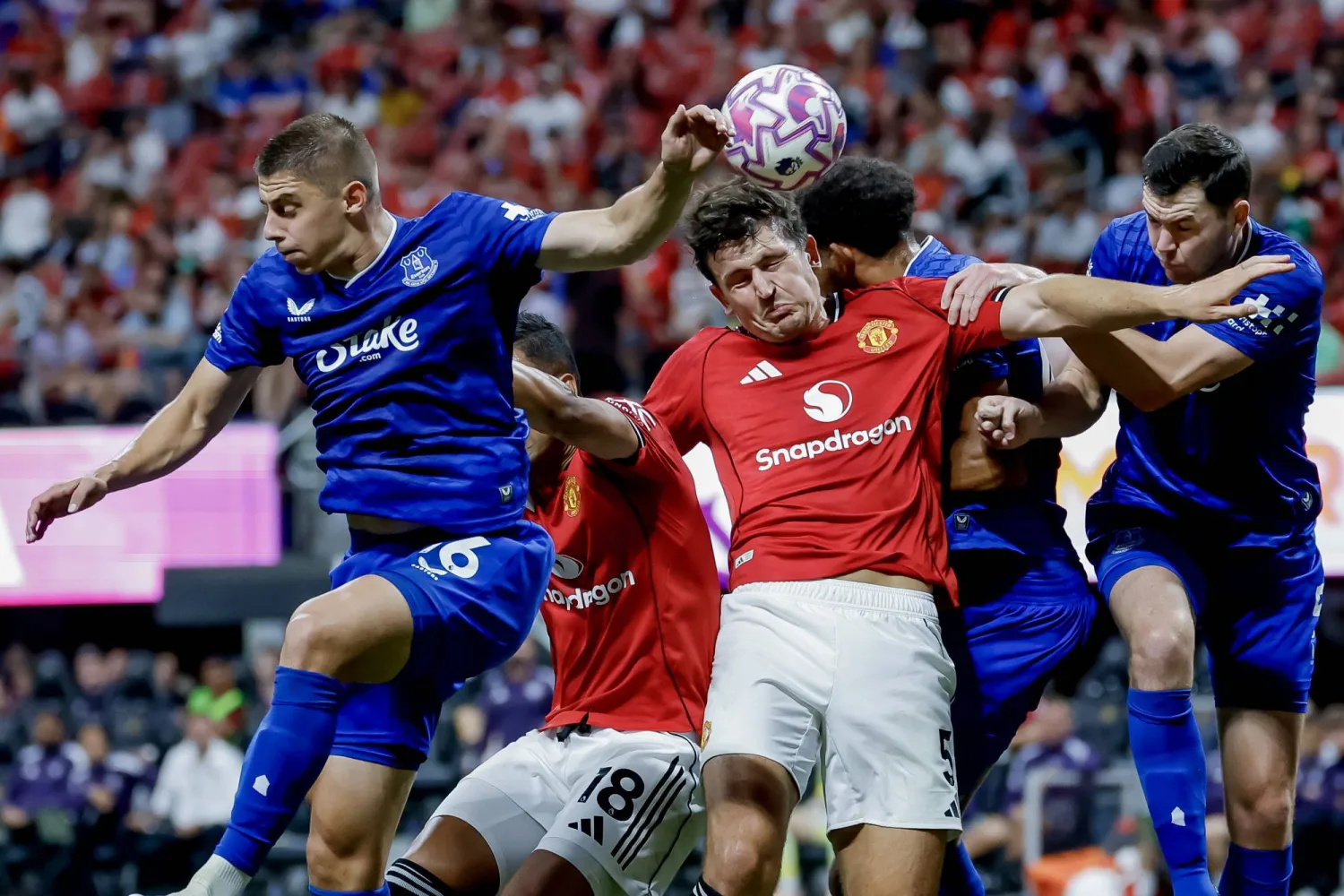 هاري ماغواير من مانشستر يونايتد في مواجهة فيتالي ميكولينكو وجيمس تاركوفسكي من إيفرتون خلال مباراة ودية ضمن سلسلة الدوري الإنجليزي الممتاز الصيفية في أتلانتا (إ.ب.أ)