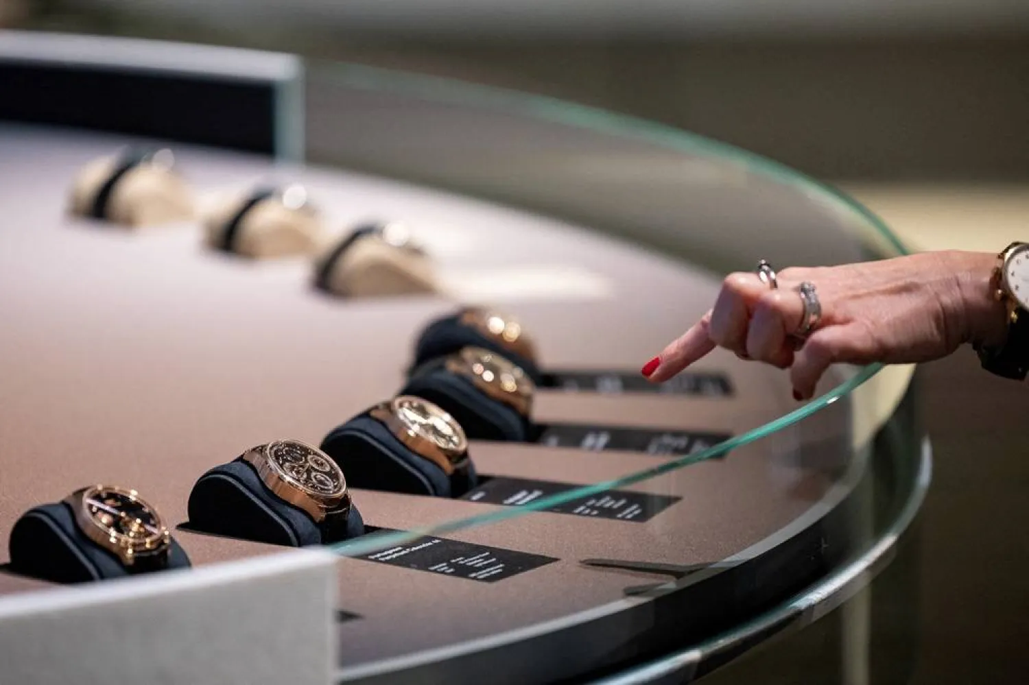A visitor looks at watch models at the IWC Schaffhausen booth at the Watches and Wonders exhibition in Geneva, Switzerland, April 9, 2024. (Reuters) 