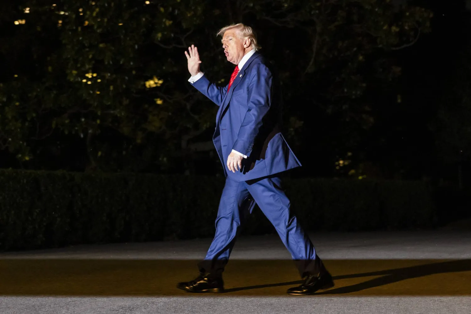 الرئيس الأميركي يلوح بيده لدى عودته إلى البيت الأبيض بعد عطلة نهاية أسبوع في بيدمينستر (إ.ب.أ)