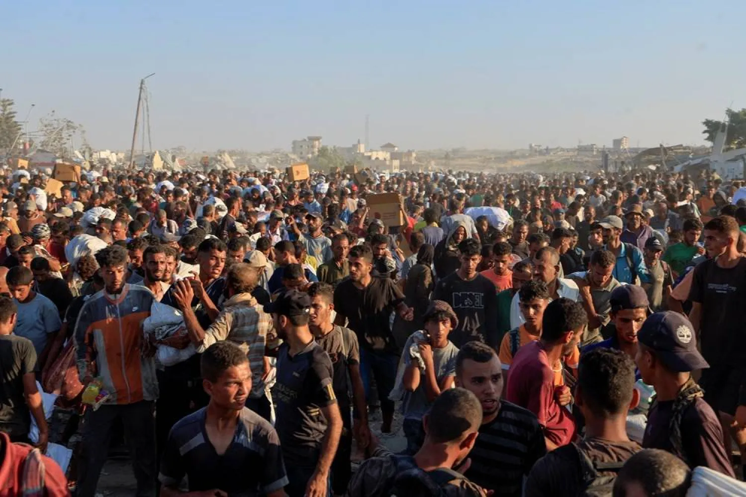  Palestinians seek aid supplies in Khan Younis, southern Gaza Strip, August 4, 2025. (Reuters)