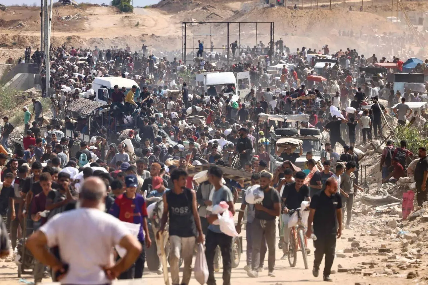 Displaced Palestinians gather for food aid at Nuseirat corridor in central Gaza on Monday (AFP)