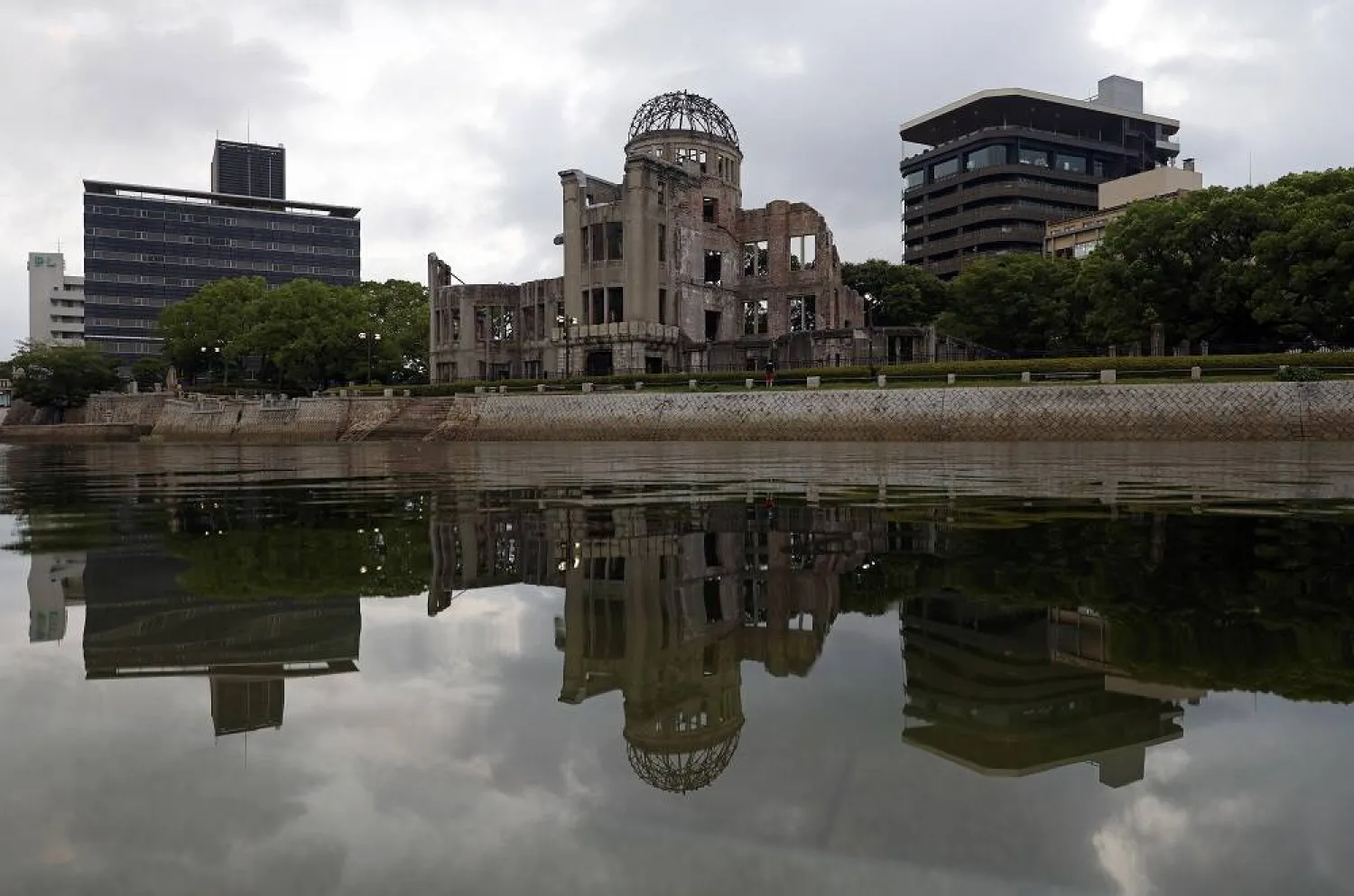 The A-Bomb Dome is reflected on the Motoyasu river at the Peace Memorial Park in Hiroshima, western Japan, early 05 August 2025. (EPA)