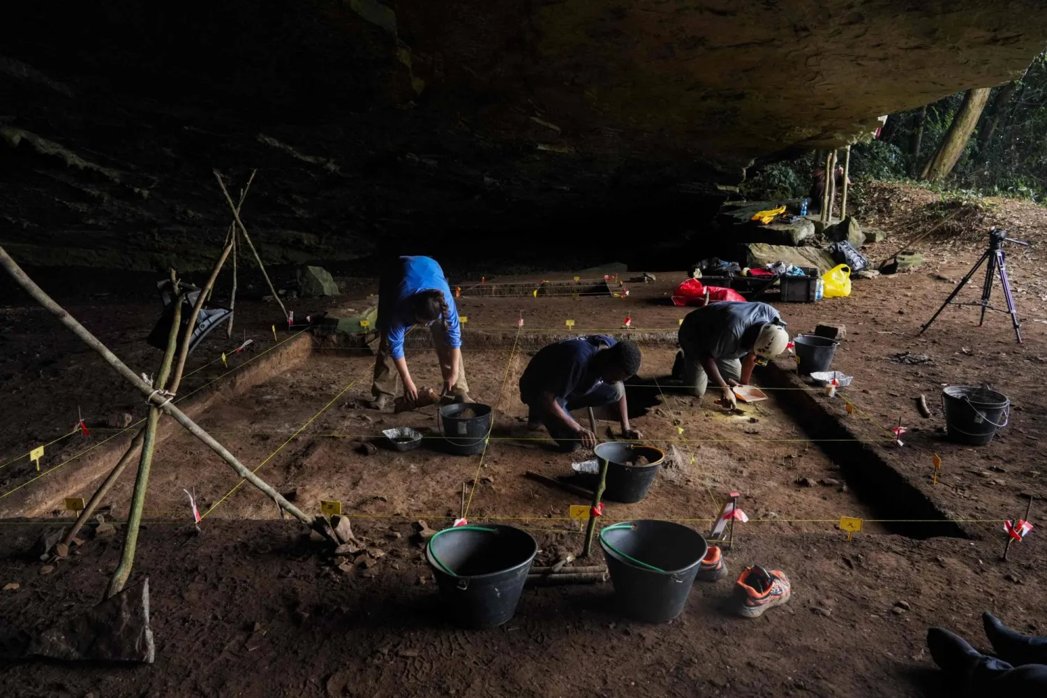 Archaeology students actively participate in archaeological excavations within a marked square inside Youmbidi Cave in Lastourville, on June 27, 2025. (Photo by Nao Mukadi / AFP)