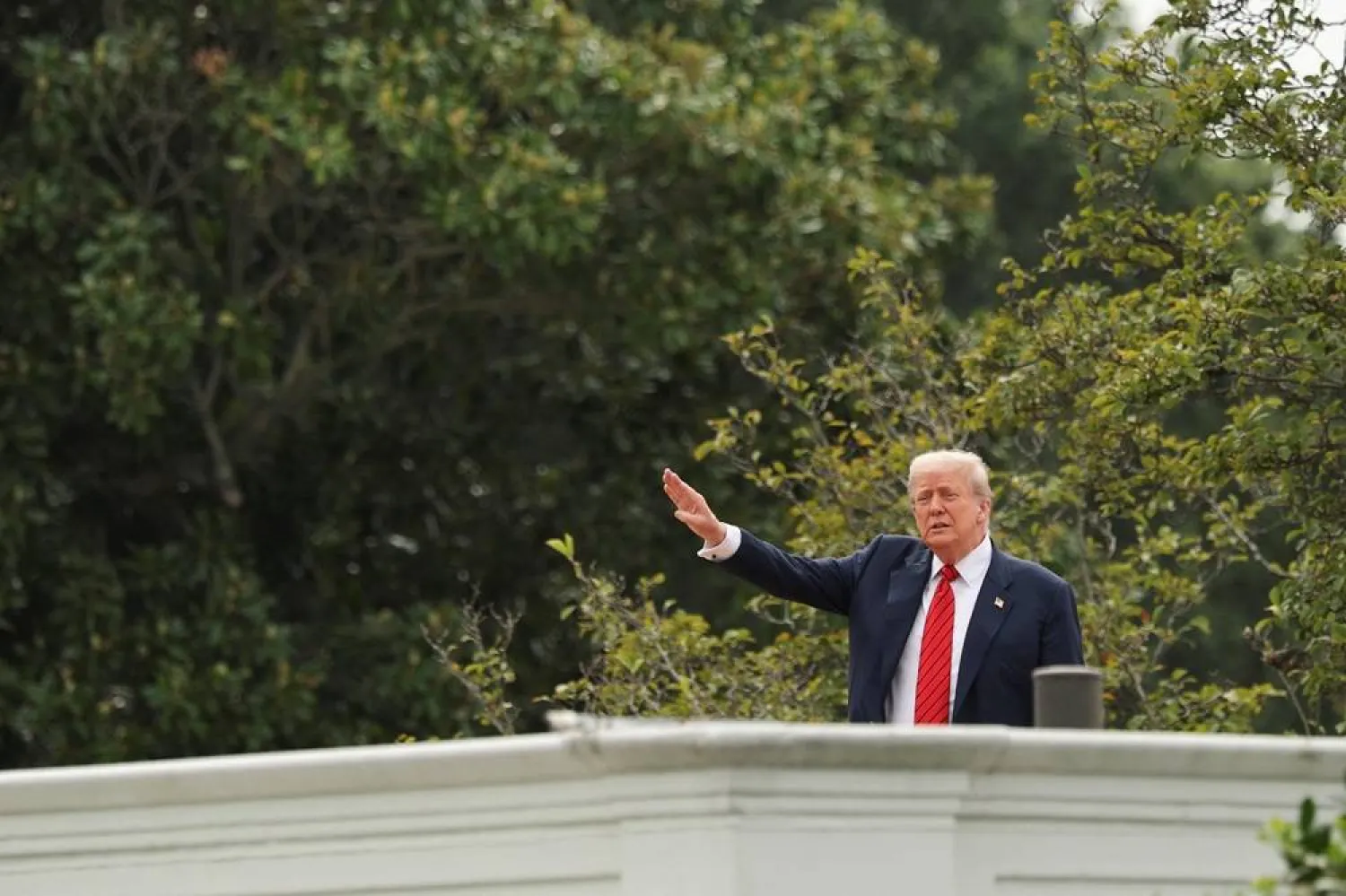 US President Donald Trump gestures as he jokes to reporters that he's planning to install nuclear missiles, on a with an architect and aides on the roof of the White House in Washington, DC, US, August 5, 2025. (Reuters) 