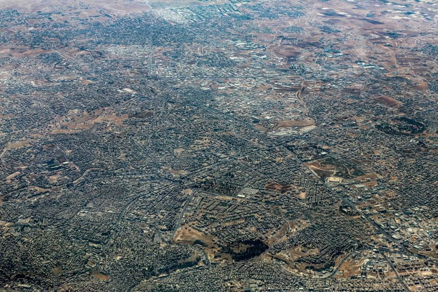 This aerial view shot from a German Air Force (Luftwaffe) military transport aircraft during an airdrop relief mission shows the scene in the Gaza Strip on August 5, 2025. (AFP)