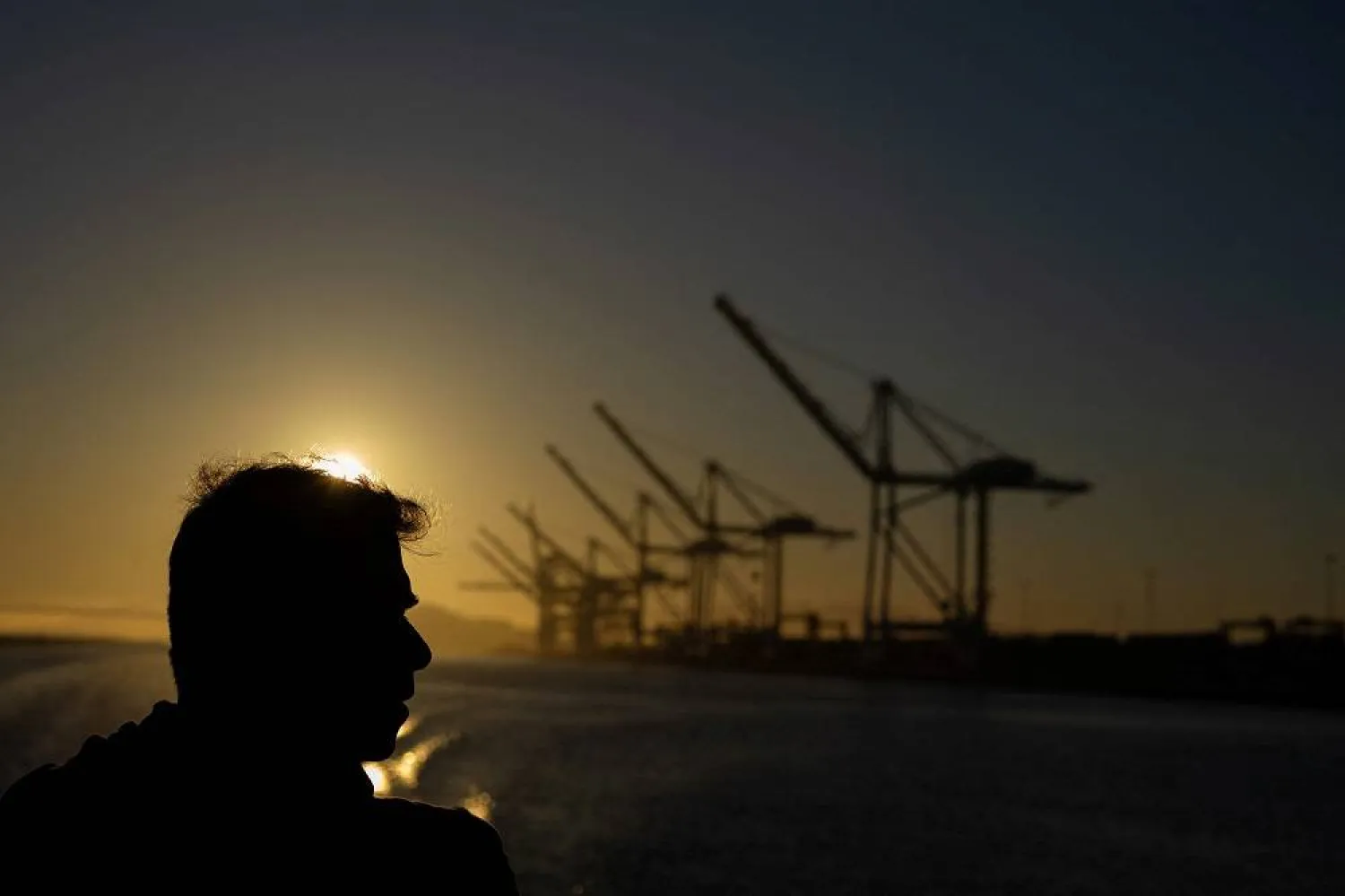 A ferry passenger looks at the port of Oakland, California, US, August 4, 2025. (Reuters)