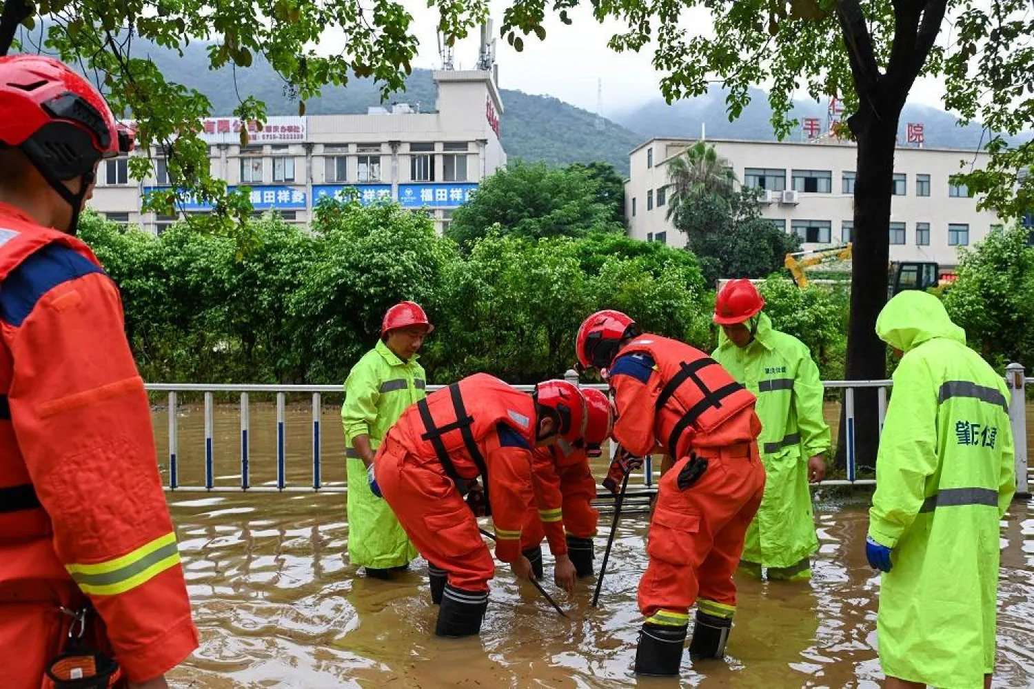 Rescuers open a manhole to drain water on a flooded road in Duanzhou District of Zhaoqing City, Guangdong Province, China, 05 August 2025. (EPA/ Xinhua) 