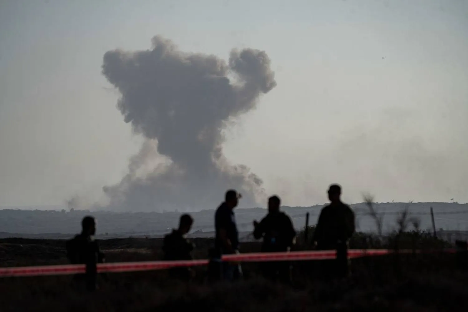 30 July 2025, Israel: Israeli right-wing settlers look at smoke rising from the Gaza Strip, seen from southern Israel. (dpa) 