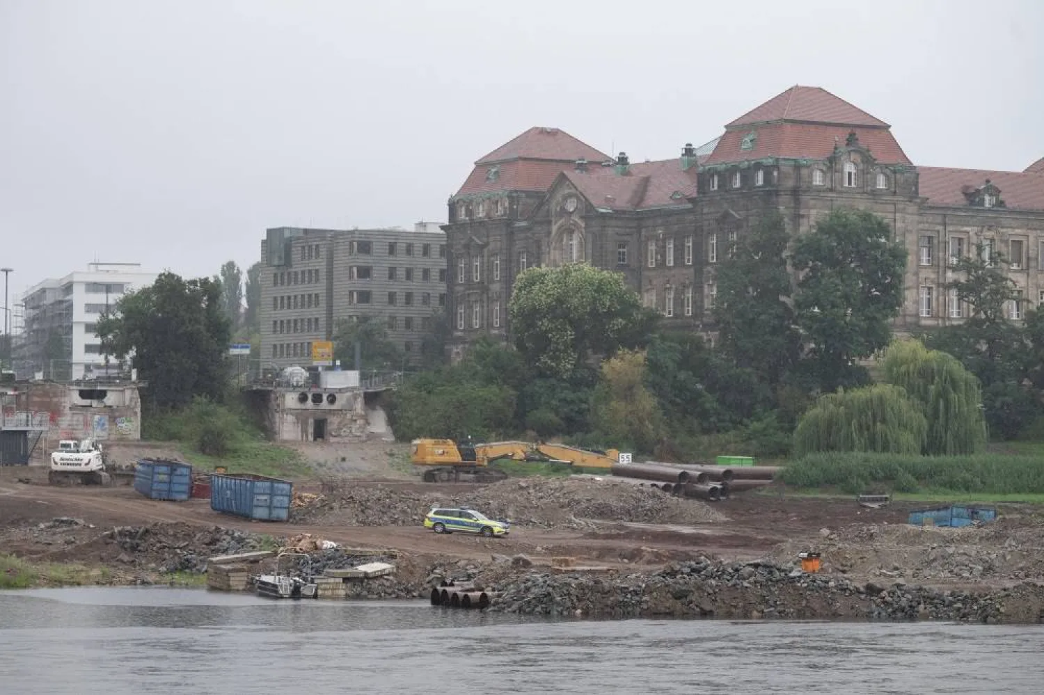 05 August 2025, Saxony, Dresden: A police vehicle stands on the construction site at the demolished Carola Bridge on the Neustadt side of the Elbe in front of the Saxon State Chancellery. (dpa)