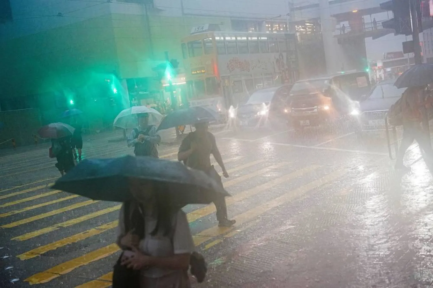 Pedestrians walk past a flooded area during heavy rains, in Hong Kong, China, August 5, 2025. (Reuters)