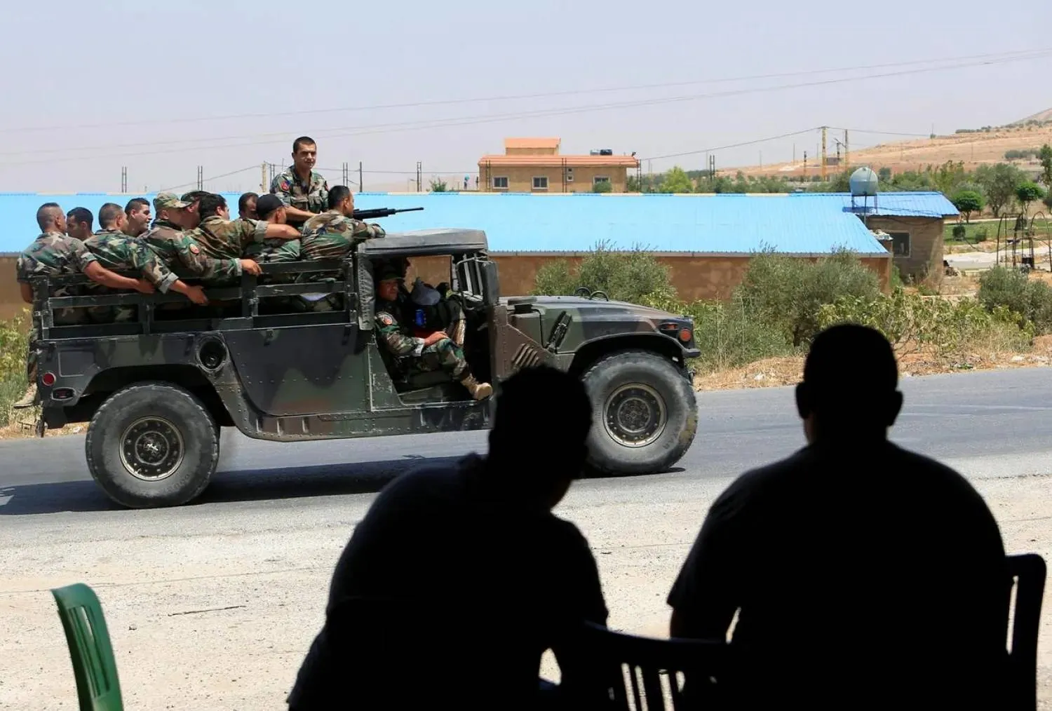  People watch as Lebanese army soldiers patrol a street in the Bekaa Valley, Lebanon July 22, 2017. (Reuters)