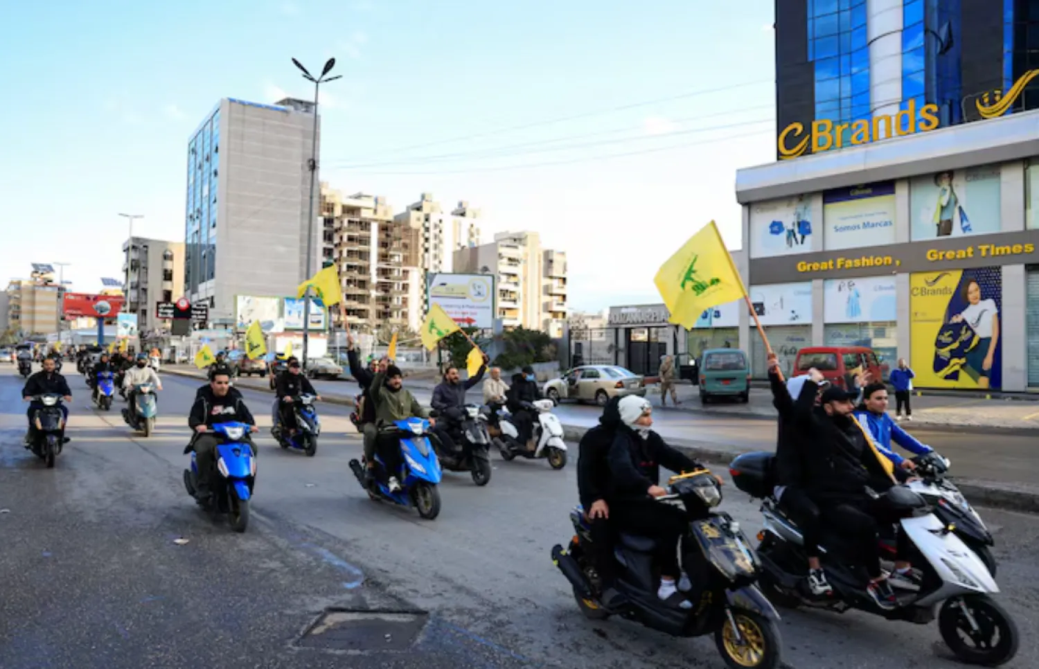 Men carry Hezbollah flags while riding on two wheelers, at the entrance of Beirut's southern suburbs, in Lebanon, November 27, 2024. REUTERS/Thaier Al-Sudani/File Photo 
