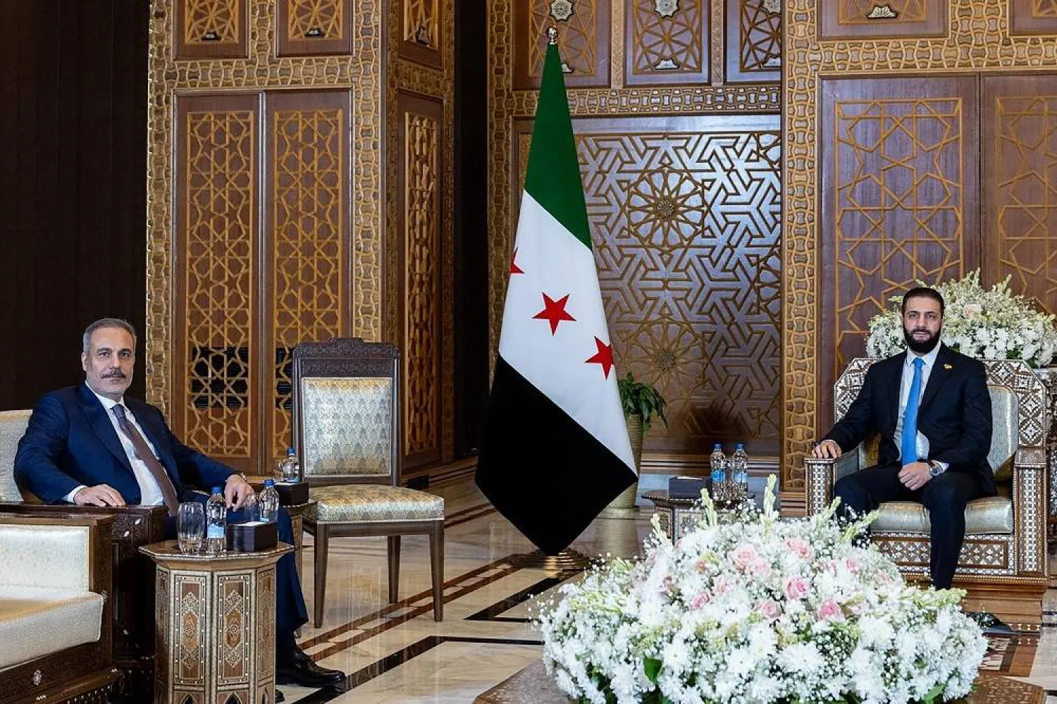 A handout picture released by the Turkish Foreign Ministry on August 7, 2025, shows Syrian interim President Ahmed al-Sharaa meeting with Türkiye’s Foreign Minister Hakan Fidan in Damascus. (Turkish Foreign Ministry / AFP) 