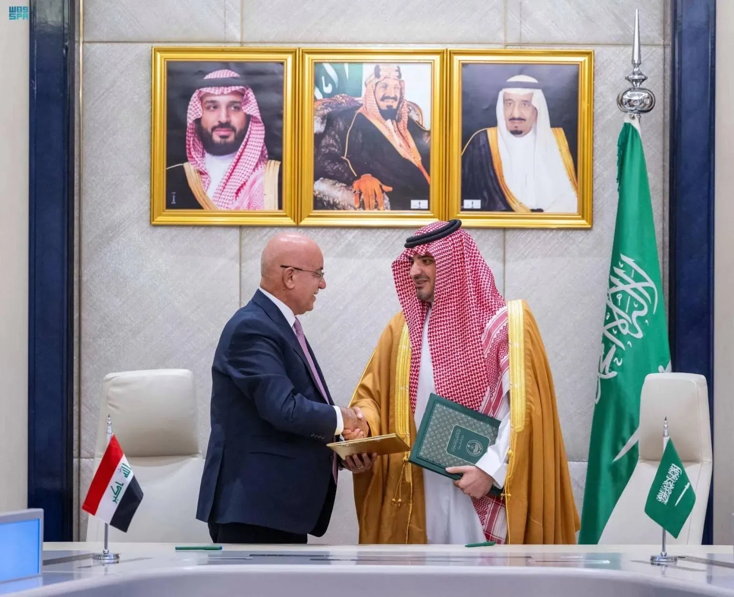 Saudi Interior Minister Prince Abdulaziz bin Saud and Iraqi Health Minister and head of the Supreme Committee for Combating Drugs Dr. Saleh Al-Hasnawi signing a memorandum of understanding (SPA) 