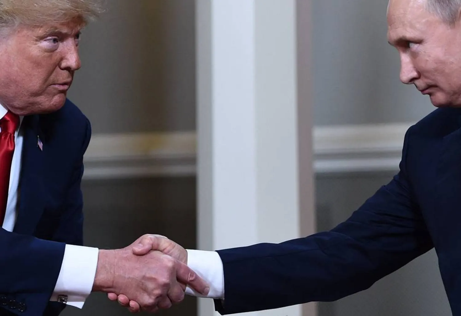  In this file photo taken on July 16, 2018, US President Donald Trump (L) and Russian President Vladimir Putin shake hands ahead a meeting in Helsinki. (AFP)