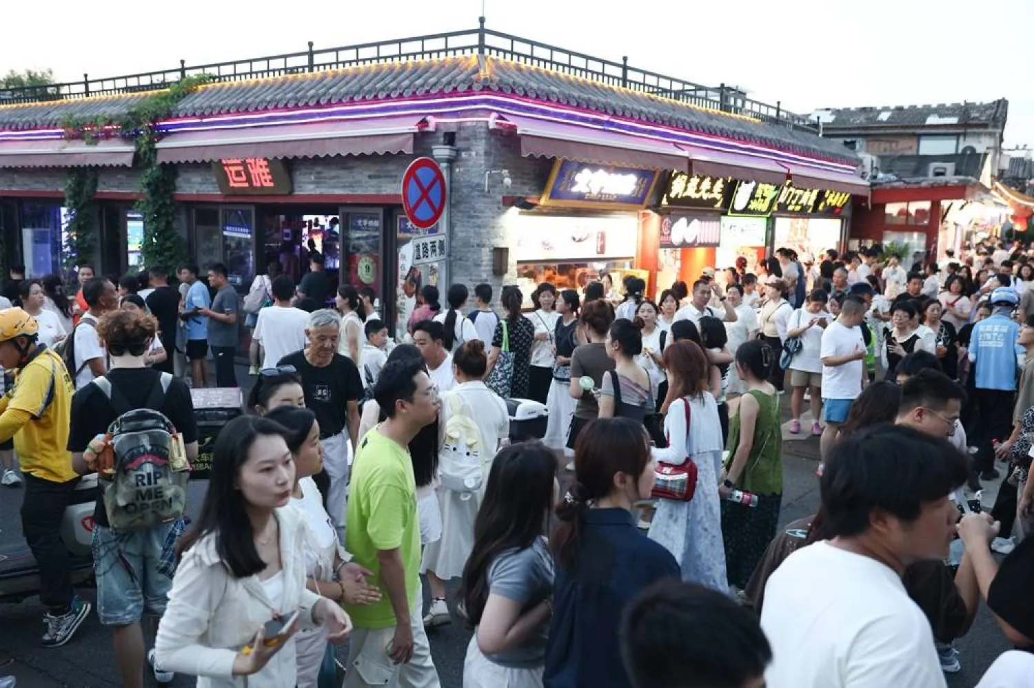 Tourist walk near Houhai in Beijing, China, 07 August 2025. (EPA)