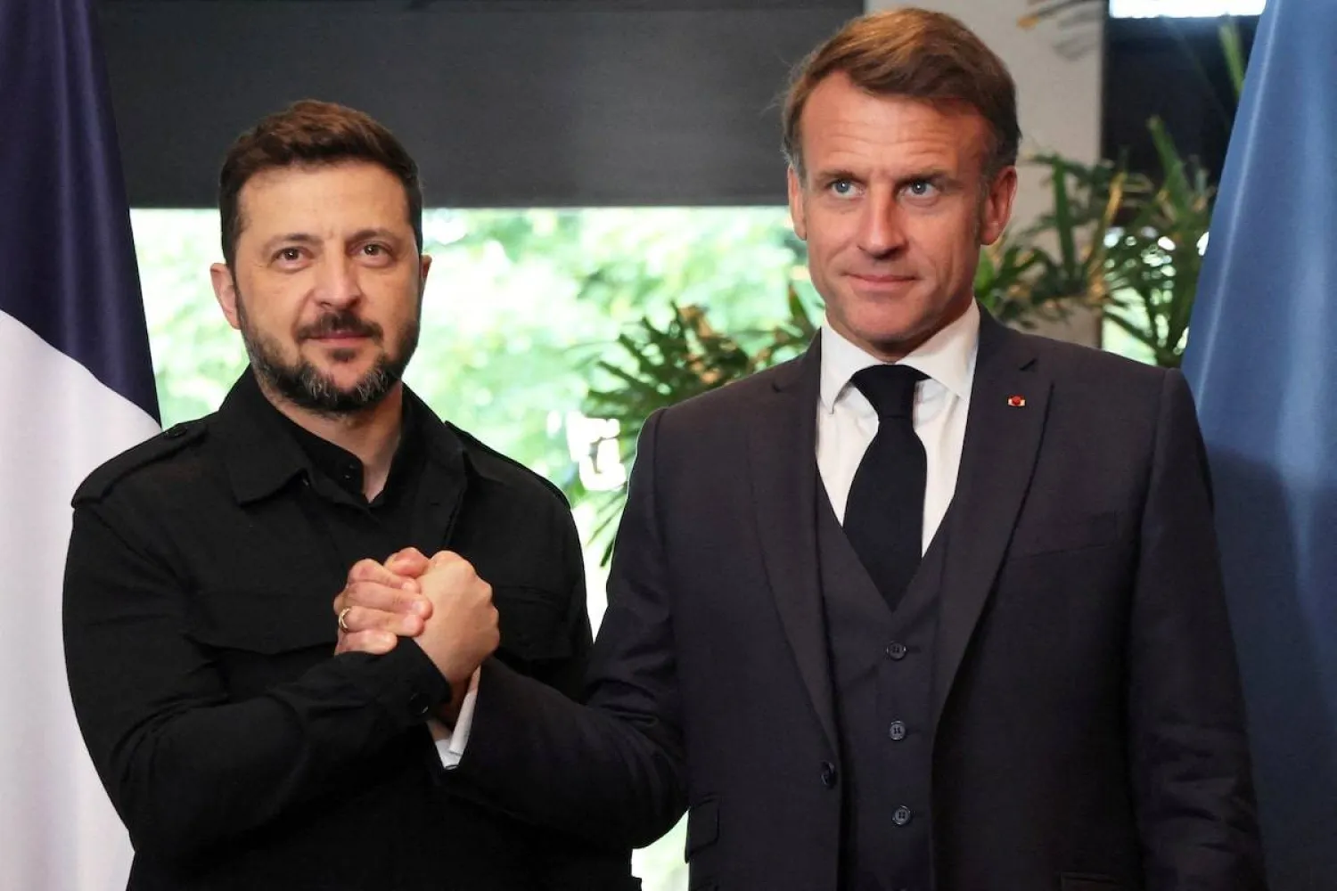 France's President Emmanuel Macron and Ukraine's President Volodymyr Zelenskiy shake hands, as they meet on the sidelines of the two-day NATO's Heads of State and Government summit, in The Hague, Netherlands June 24, 2025. (Ludovic Marin/Pool via Reuters/File) 