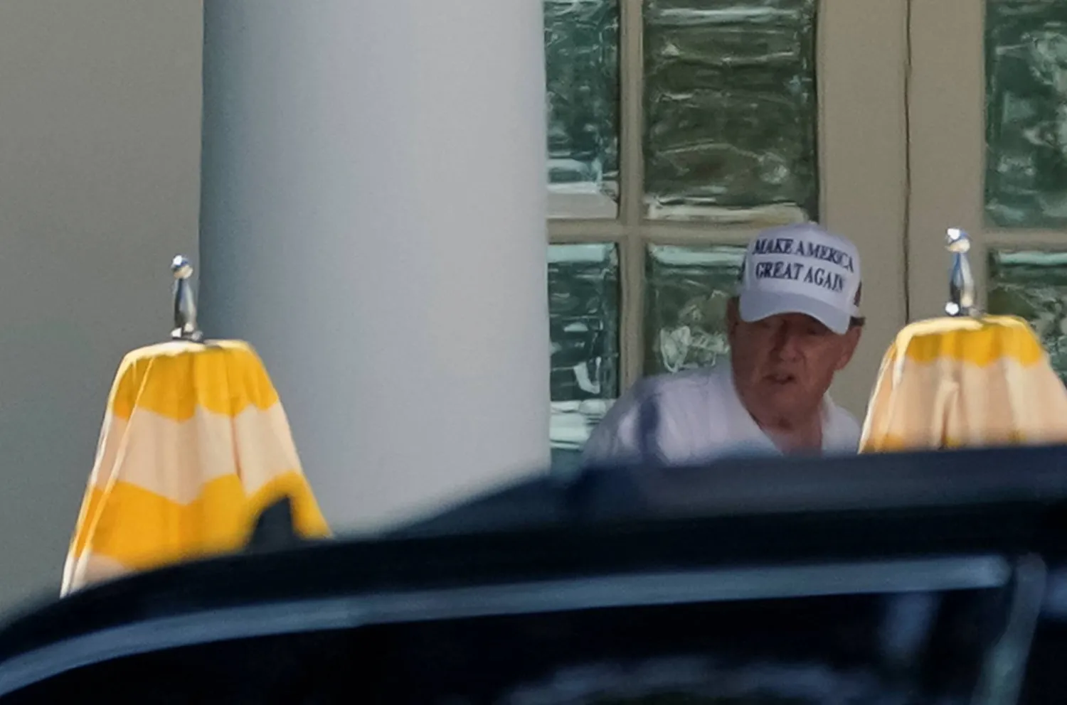 US President Donald Trump, wearing a Make America Great Again hat, walks past the Oval Office at the White House, in Washington, D.C., US, August 9, 2025. REUTERS/Nathan Howard