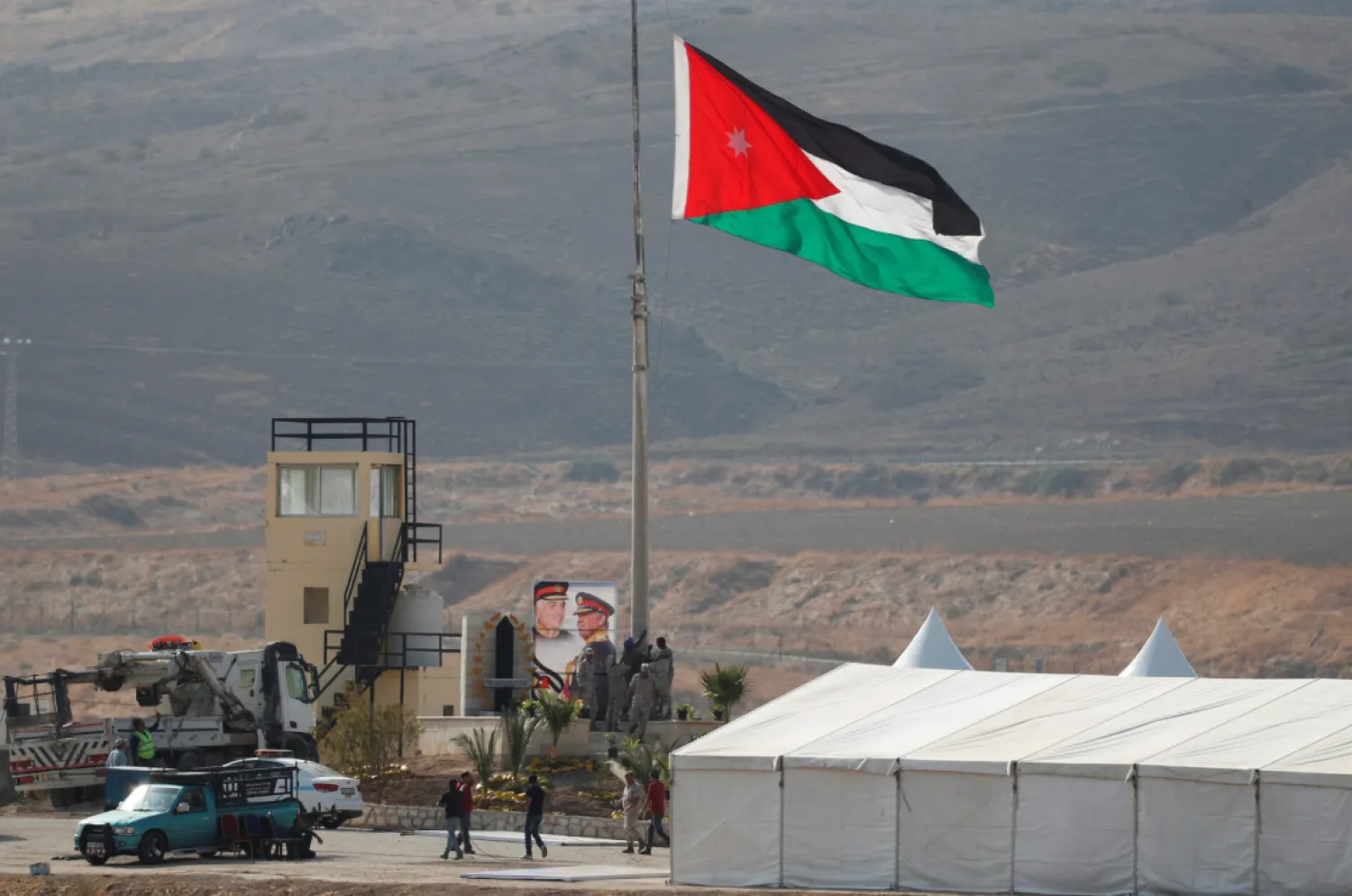 A Jordanian national flag is lifted near a tent at the "Island of Peace" in an area known as Naharayim in Hebrew and Baquora in Arabic, on the Jordanian side of the border with Israel, as seen from the Israeli side November 10, 2019. REUTERS/Ronen Zvulun