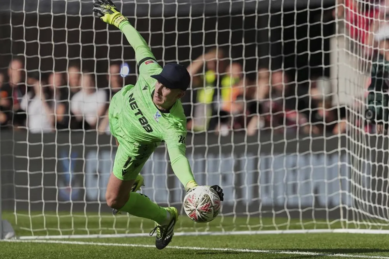 Crystal Palace's goalkeeper Dean Henderson saves during a penalty shootout during the FA Community Shield final soccer match between Liverpool and Crystal Palace at Wembley Stadium in London, Sunday, Aug. 10, 2025. (AP)