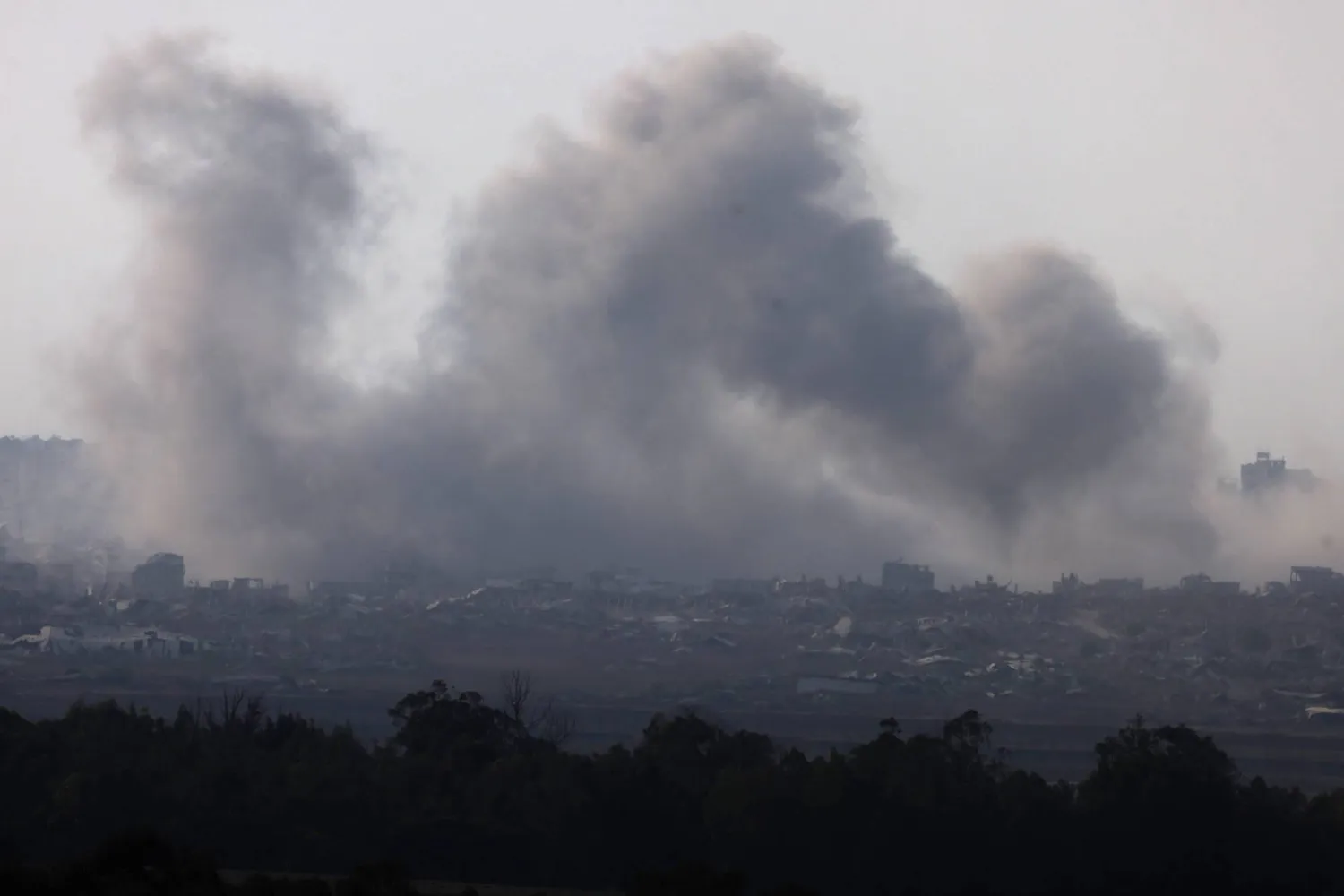 This picture taken from a position on the Israeli border with the Gaza Strip, shows smoke rising during an Israeli strike on the besieged Palestinian territory on August 10, 2025. (Photo by Menahem KAHANA / AFP)