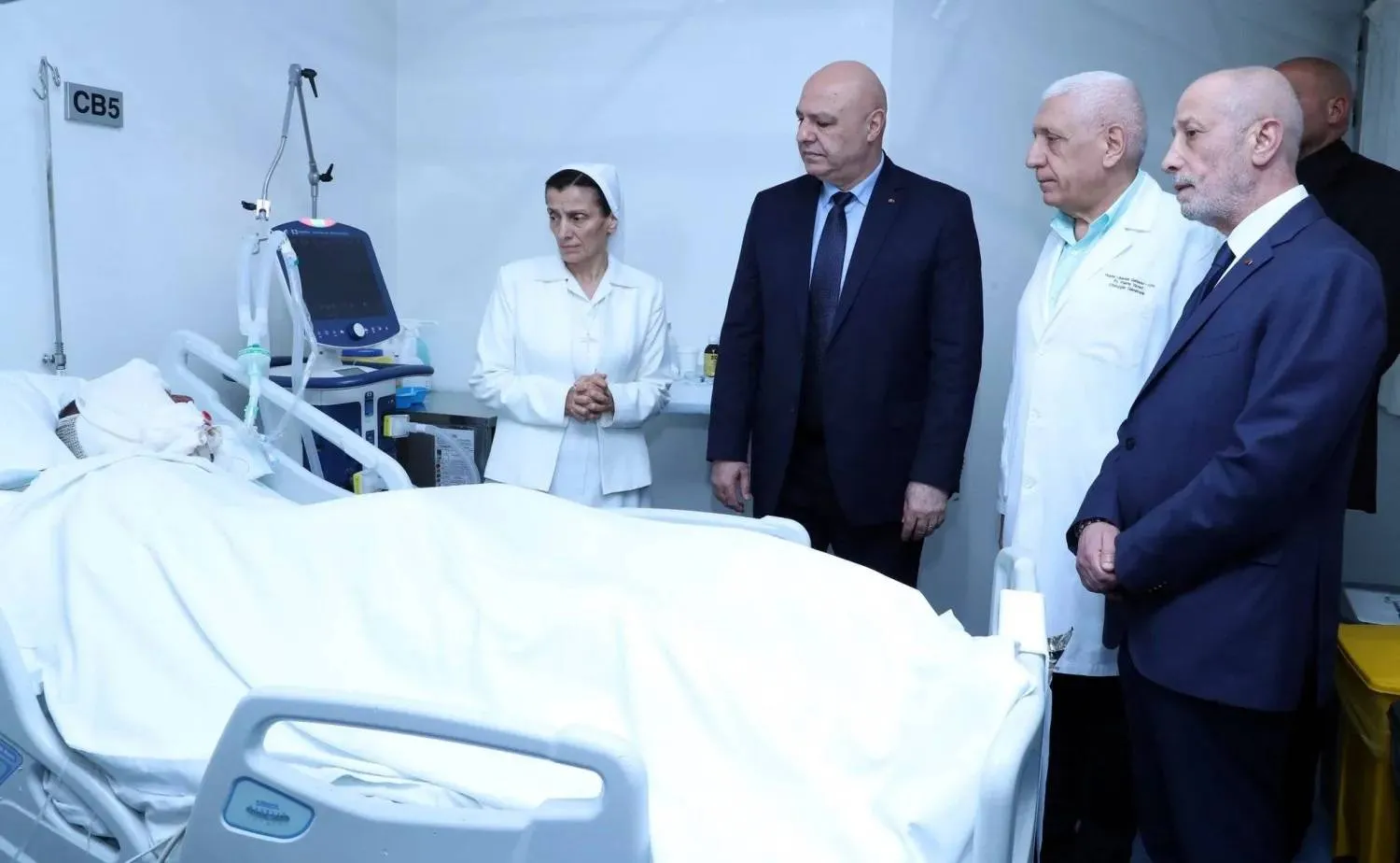 President Joseph Aoun visits a soldier in hospital where he is receiving treatment to injuries sustained during the dismantling munitions in an arms depot on Saturday. (Lebanese Presidency) 