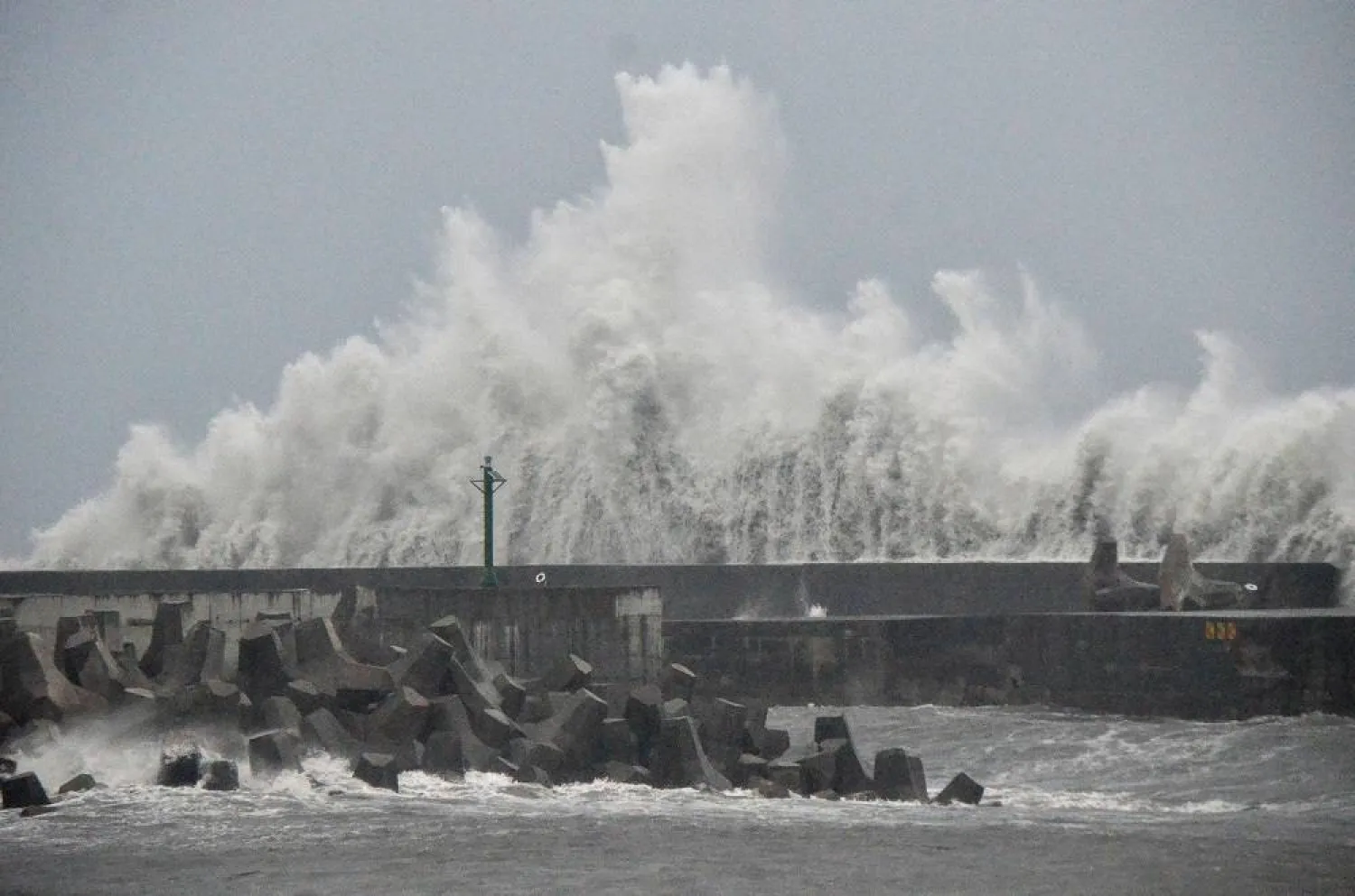 This picture taken and released by Taiwan's Central News Agency (CNA) on August 13, 2025 shows waves generated by Typhoon Podul breaking along the coast in Taitung. (AFP)