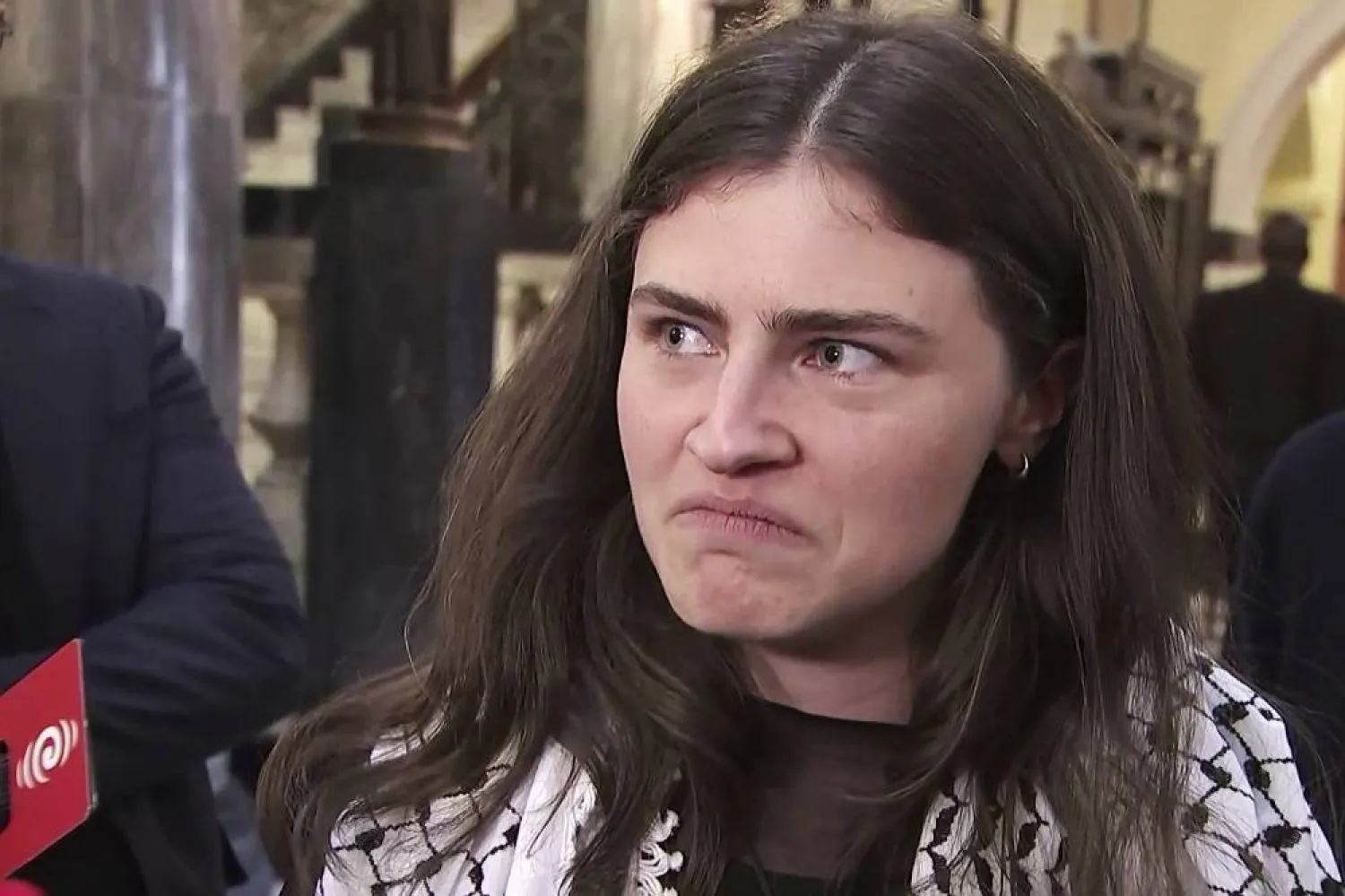 In this image made from video, New Zealand lawmaker Chlöe Swarbrick talks to the media after she was thrown out of Parliament, in Wellington, New Zealand, Tuesday, Aug.3, 2025 (Chino Barrett-Lovie/Stuff via AP)