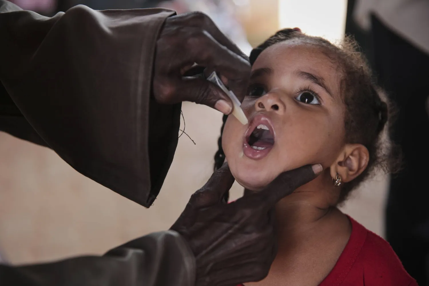 A Sudanese girl receives an oral cholera vaccine during a 10-day vaccination campaign conducted by health ministry workers in Khartoum, Sudan, Wednesday, Aug. 13, 2025. (AP Photo/Marwan Ali)