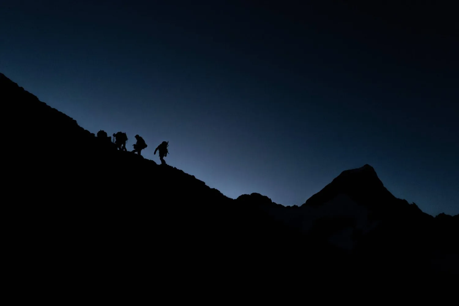 (FILES) Mountaineers hike to reach the Glacier de la Selle in the Ecrins Massif in Saint-Christophe-en-Oisans, early in the morning on July 9, 2025. (Photo by JEFF PACHOUD / AFP)
