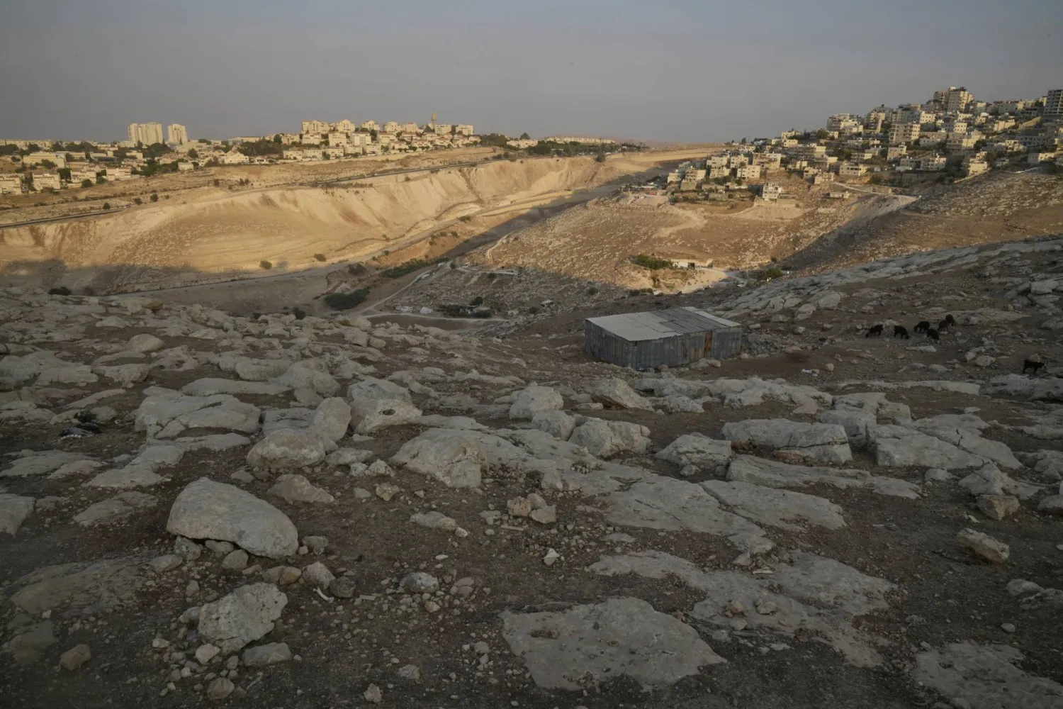 A general view shows the E1 area, an open tract of land east of Jerusalem, between the Israeli settlement of Maale Adumim, left and the occupied West Bank town of Eizariya, right, Thursday, Aug. 14, 2025. (AP Photo/Nasser Nasser)