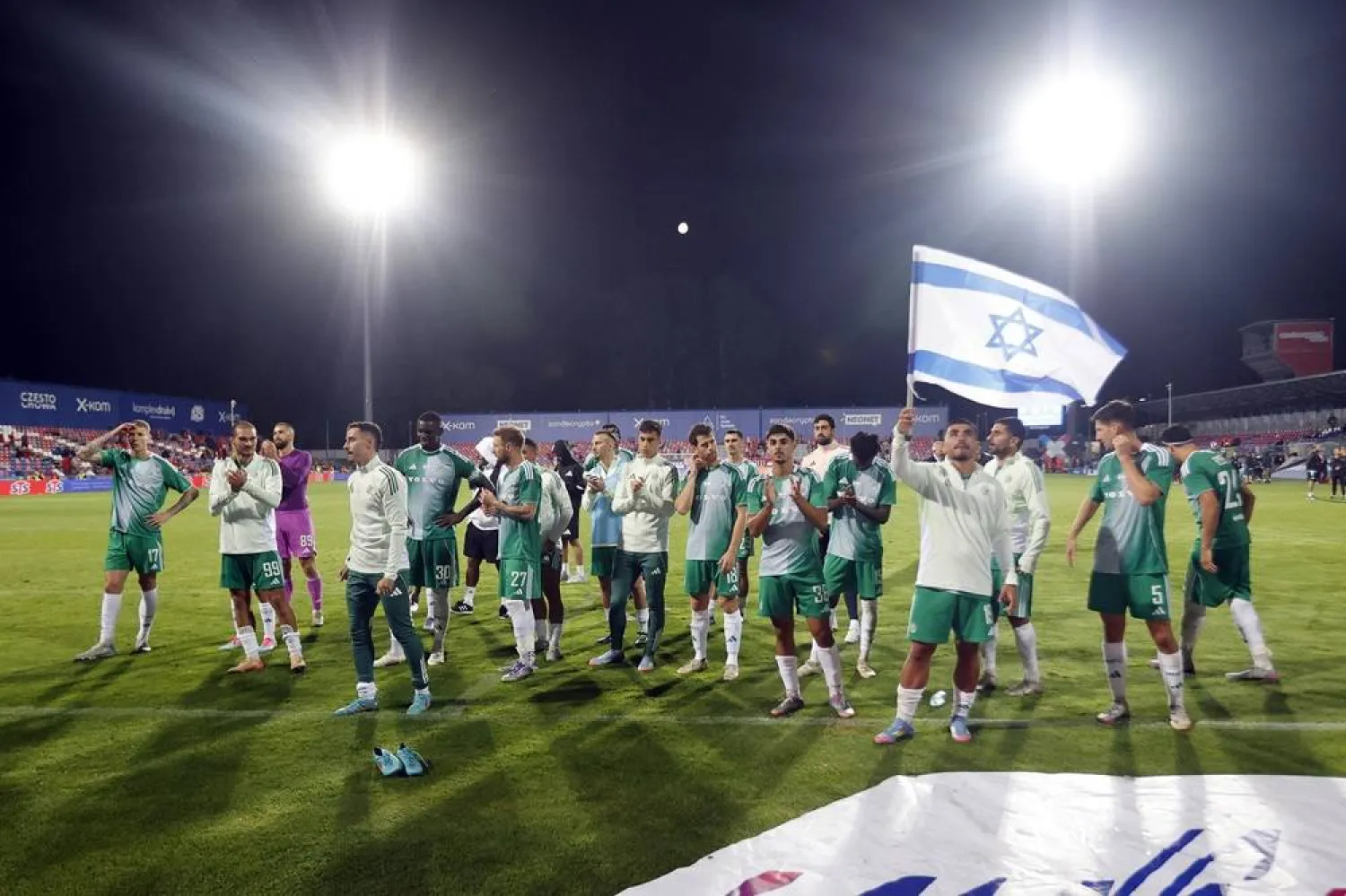 Maccabi's soccer players celebrate with their supporters after winning the UEFA Europa Conference League qualifiers third round, 1st leg soccer match between Rakow Czestochowa and Maccabi Haifa in Czestochowa, Poland, 07 August 2025. (EPA)