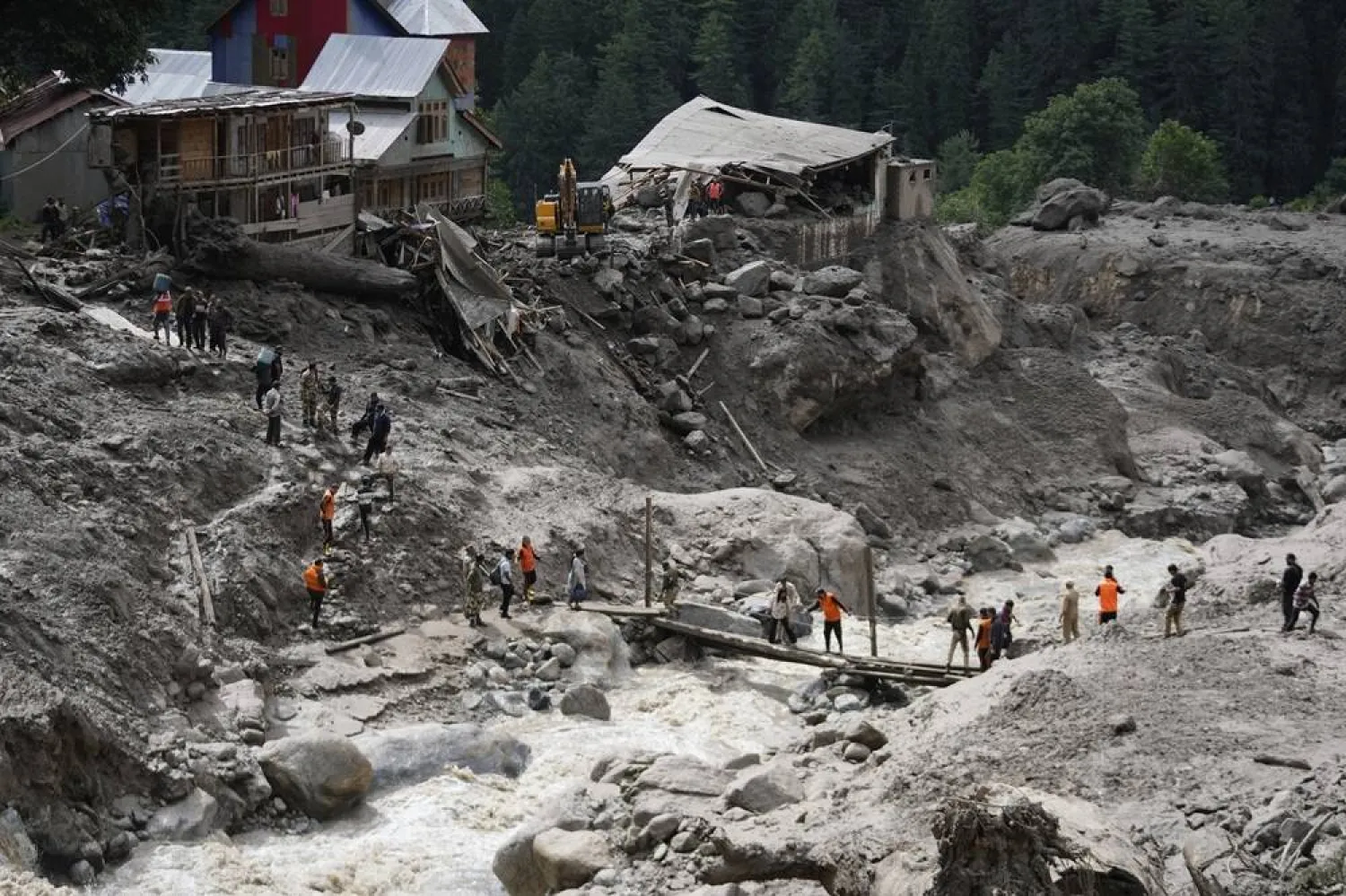  Stranded pilgrims are helped across a water channel using a makeshift bridge a day after flash floods in Chositi village, Kishtwar district, Indian-controlled Kashmir, Friday, Aug. 15, 2025. (AP) 