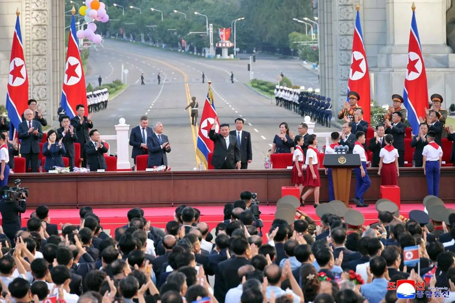 This picture taken on August 14, 2025 and released from North Korea's official Korean Central News Agency (KCNA) via KNS on August 15, 2025 shows North Korea's leader Kim Jong Un (center R) waving as chairman of the Russia's State Duma, Vyacheslav Volodin (center L), looks on as they attend a convention celebrating the 80th anniversary of the liberation of Korea from Japan colonial rule in Pyongyang. (KCNA via KNS / AFP) 