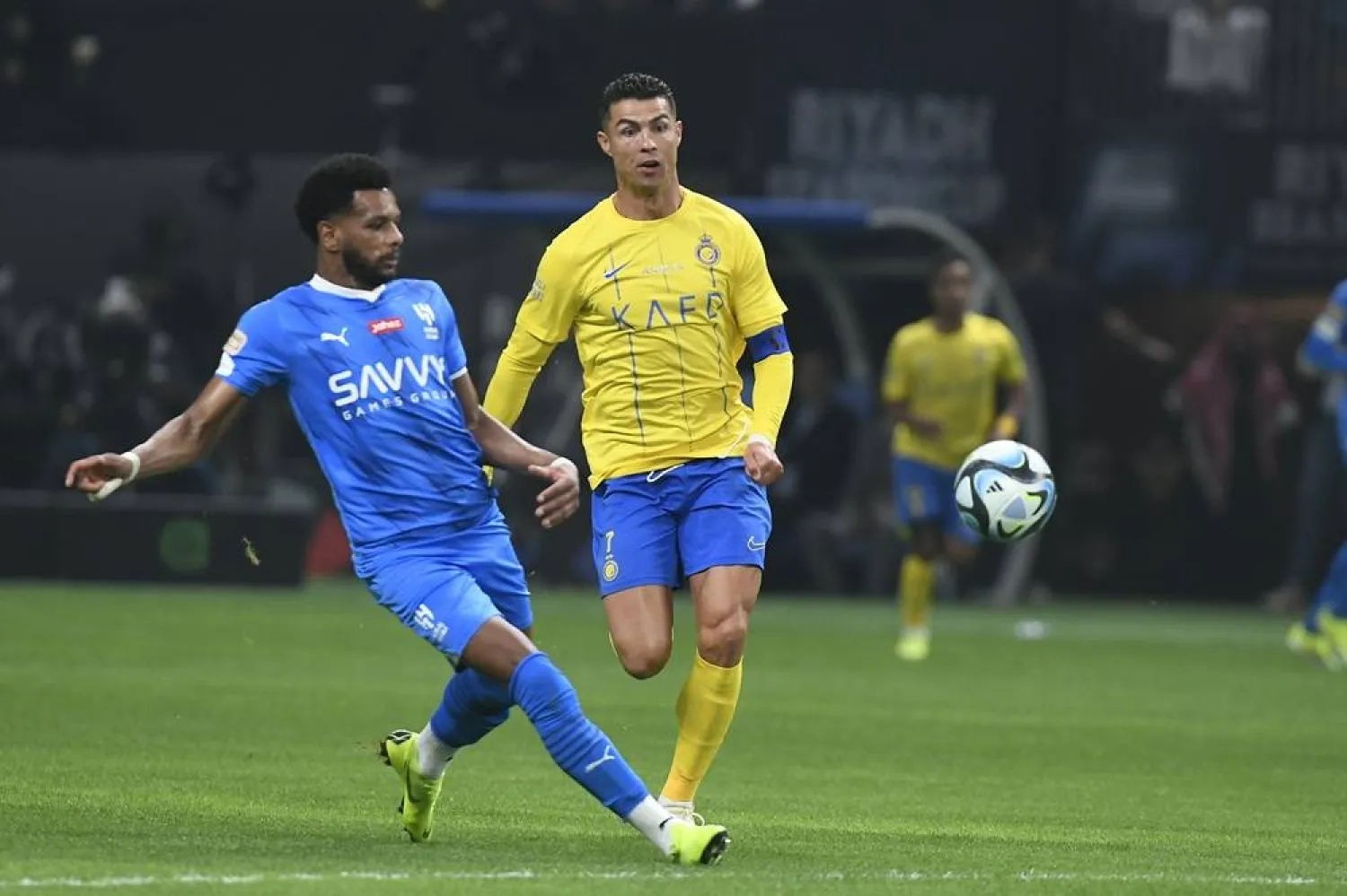 Al-Nassr's Cristiano Ronaldo, right, and Al-Hilal's Al-Bulayhi challenge for the ball during Riyadh Season Cup 2024 final match at the Kingdom Arena Stadium in Riyadh, Saudi Arabia, Thursday, Feb. 8, 2024. (AP)