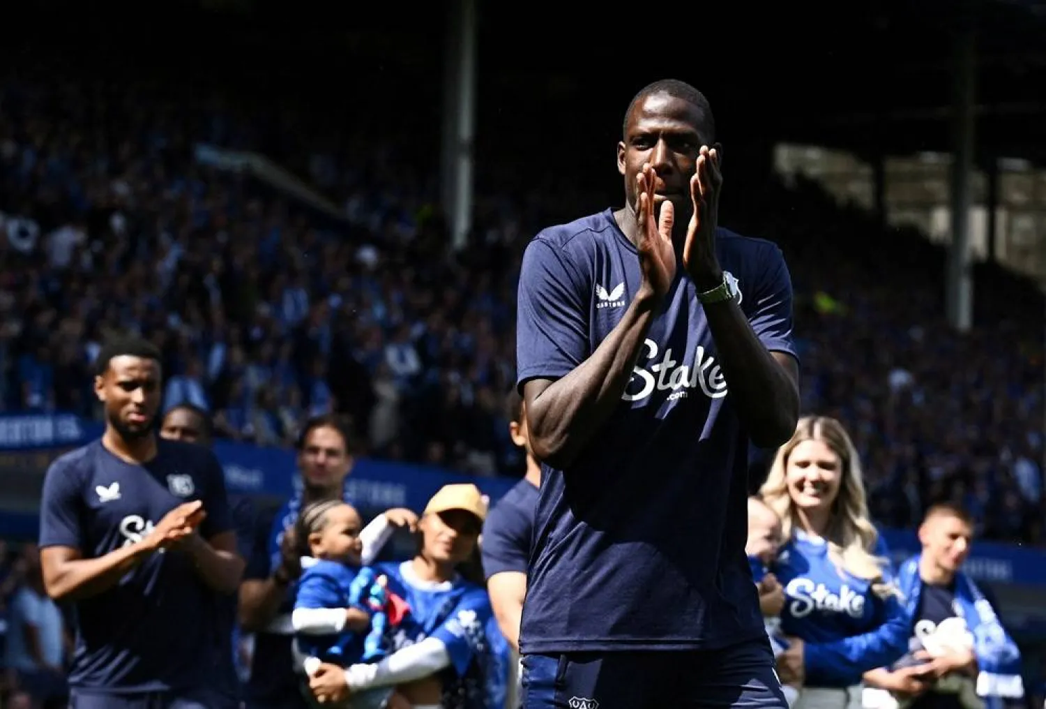 Football - Premier League - Everton v Southampton - Goodison Park, Liverpool, Britain - May 18, 2025 Everton's Abdoulaye Doucoure applauds fans as he walks on the pitch during a commemorative ceremony after his last match at Goodison Park. (Reuters)