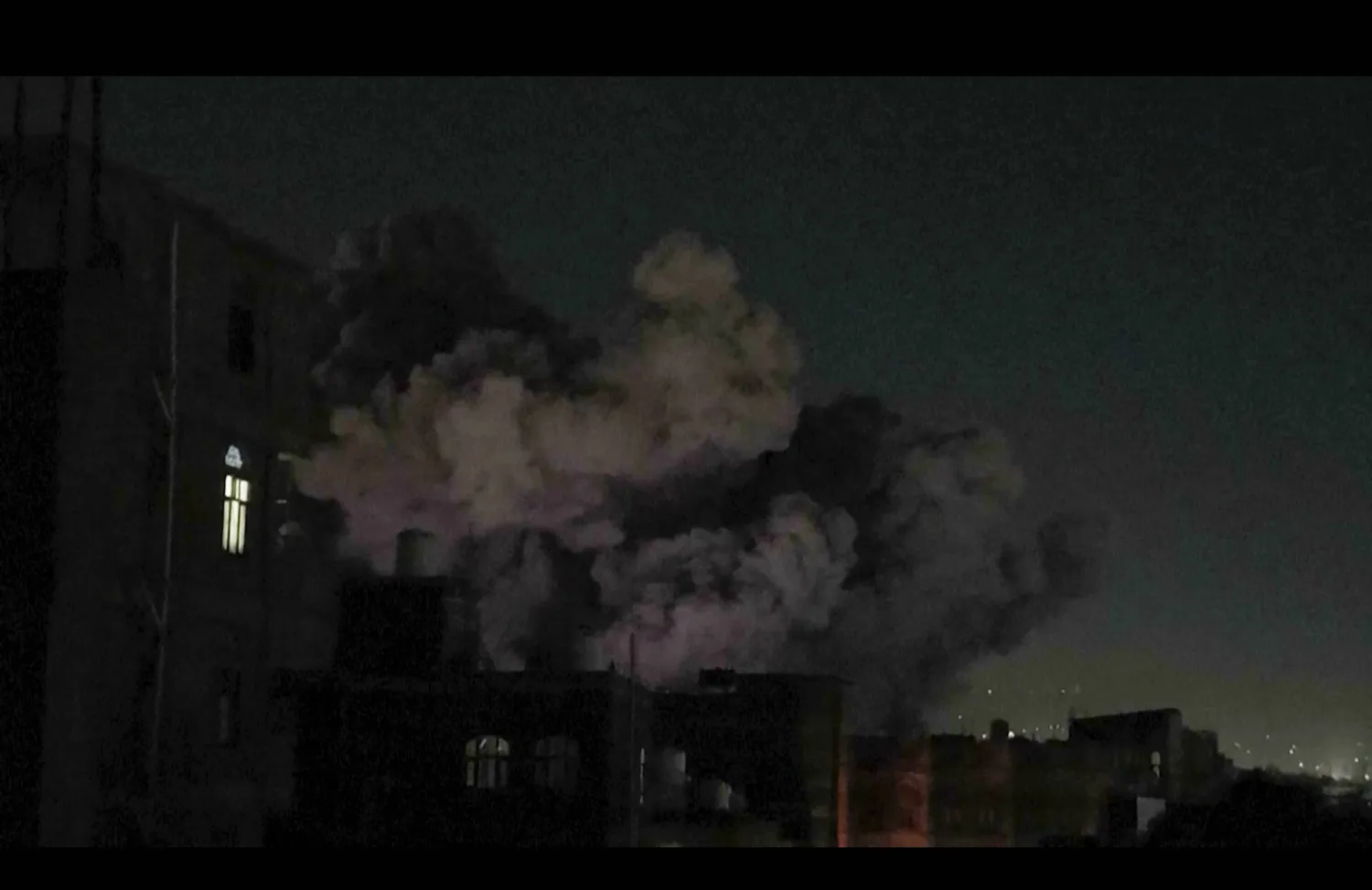 In this image made from video, smoke rises after a blast in Sanaa, Yemen, Friday, March 28, 2025. (AP Photo)