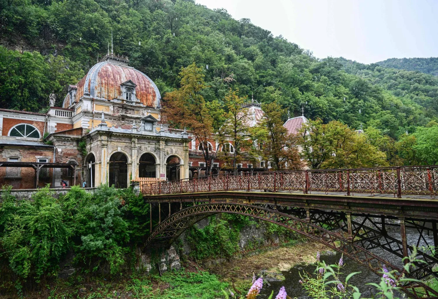 Exterior view of Neptune Imperial Baths building and the wrought iron bridge that is closed for access- in Baile Herculane on July 29, 2025. (Photo by Daniel MIHAILESCU / AFP) 